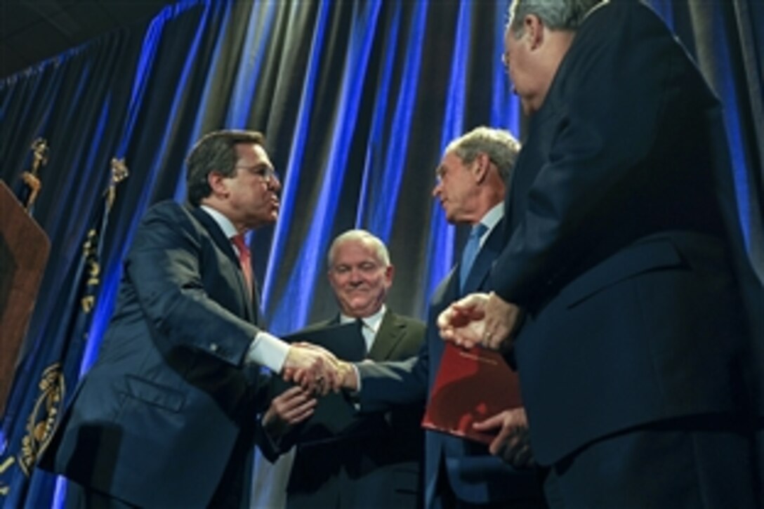Former President George W. Bush and Defense Secretary Robert M. Gates receive accolades during the Circle Ten Council Friends of Scouting dinner in Dallas, March 3, 2011. Bush introduced Gates, who gave the keynote speech. 