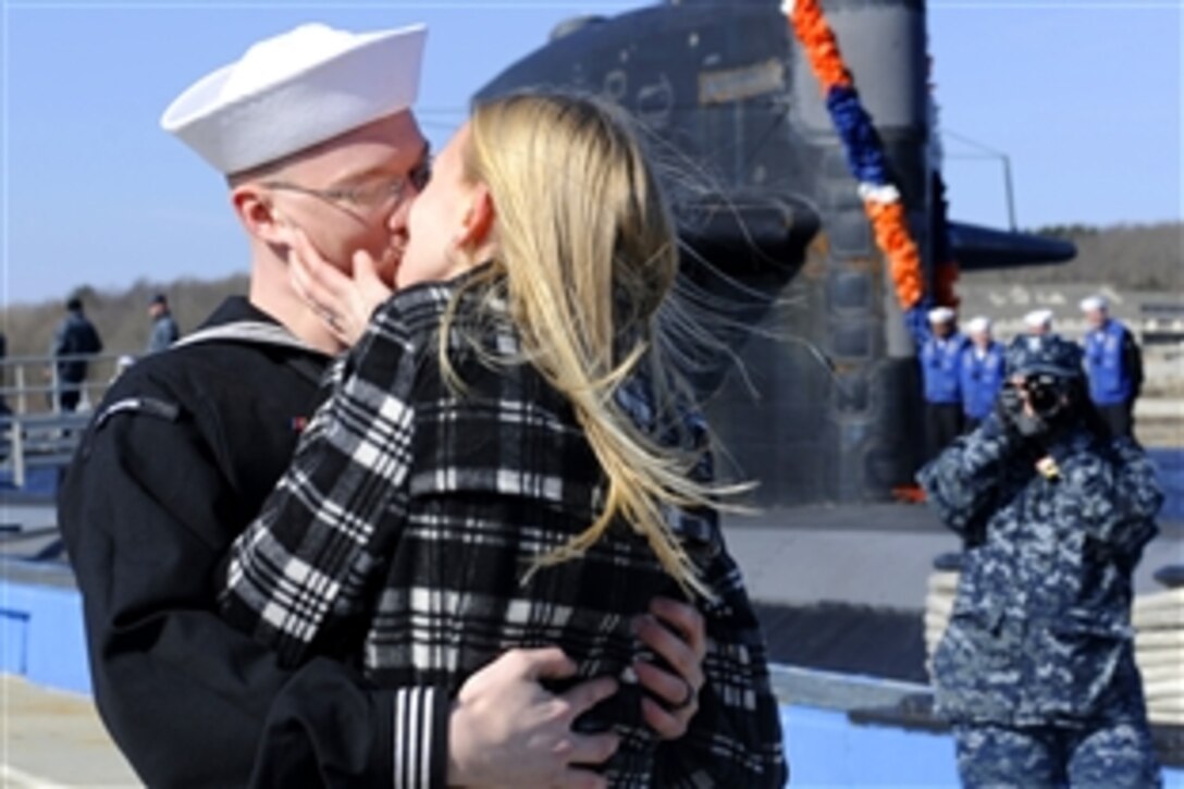 U.S. Navy Petty Officer 3rd Class Christopher Shepardpearson receives the traditional first kiss from his wife after the fast attack submarine USS Memphis returned home to Naval Submarine Base New London, Groton, Conn, March 2, 2011. Memphis completed its final overseas mission to the U.S. European Command area of responsibility and is scheduled to be decommissioned at Submarine Base New London April 1. Shepardpearson, is a Electronics Technician.
