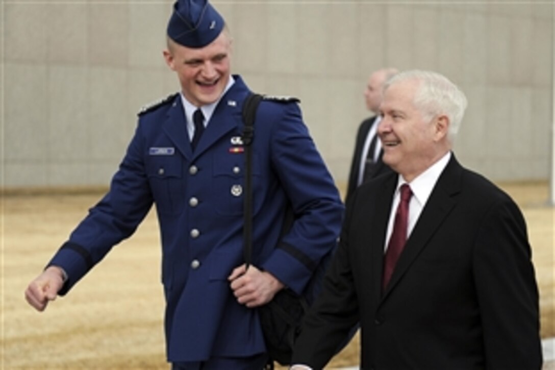 Defense Secretary Robert M. Gates walks with U.S. Air Force Academy Cadet Wing Commander Josh Larson before teaching a political science and national security class as part of the Capstone Seminar at the Air Force Academy, Colorado Springs, Colo., March 4, 2011. 