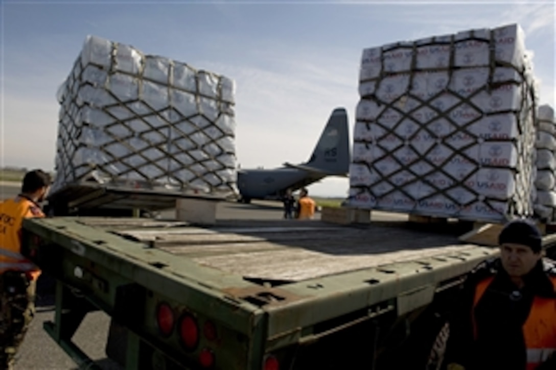 U.S. airmen load blankets, tarp and water containers provided by USAID onto a U.S. Air Force C-130 aircraft in Pisa, Italy, March 4, 2011. The airmen are from the 435th Air Mobility Squadron and the supplies will be flown to Tunisia. The U.S. government is working with the international community to meet the humanitarian needs of the Libyan people and others in their country who fled across the border because of political unrest.