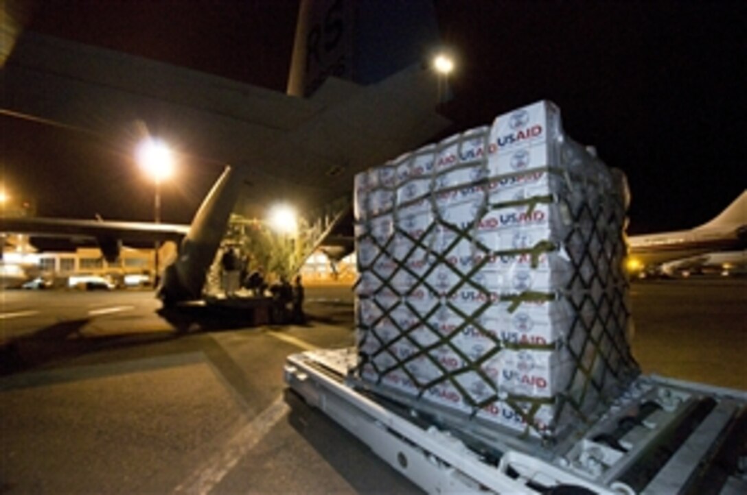 U.S. airmen unload blankets, tarp and water containers provided by USAID at Djerba-Zarzis International Airport, Djerba, Tunisia, March 4, 2011. The airmen are from the 435th Air Mobility Squadron. The U.S. government is working with the international community to meet the humanitarian needs of the Libyan people and others in their country who fled across the border during recent political unrest. 