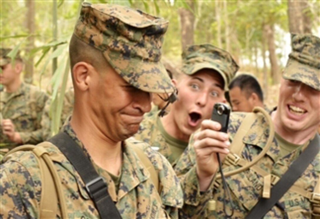 U.S. Marine Corps Lance Cpl. Miguel Gonzalez (3rd from right) , a motor transportation operator with Combat Assault Battalion, Ground Combat Element, 3rd Marine Expeditionary Brigade (Forward), III Marine Expeditionary Force, closes his eyes as a scorpion crawls on his cover during a jungle-survival training for Exercise Cobra Gold 2011 in Ban Chan Khrem, Chanthaburi province, Thailand, on Feb. 20, 2011.  Cobra Gold is a regularly scheduled joint/combined exercise designed to ensure regional peace and strengthen the ability of the Royal Thai Armed Forces to defend Thailand or respond to regional contingencies.  