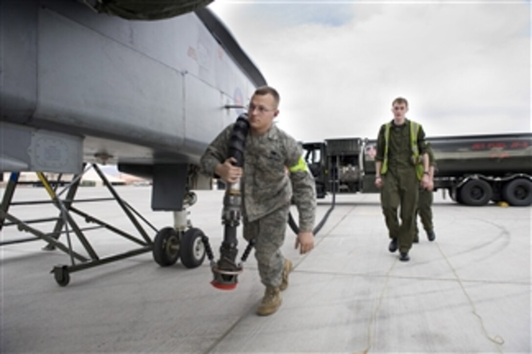 U.S. Air Force Senior Airman Nick Kester (left), with the 23rd Logistics Readiness Squadron, and British Royal Air Force Senior Aircraftman Christopher Harris, with the No. 9 Squadron, refuel a British Tornado GR4 aircraft during Red Flag 11-3 at Nellis Air Force Base, Nev., on March 1, 2011.  Red Flag is an advanced aerial combat training exercise held four to six times a year to train pilots from the U.S., NATO and other allied countries for real combat situations.  