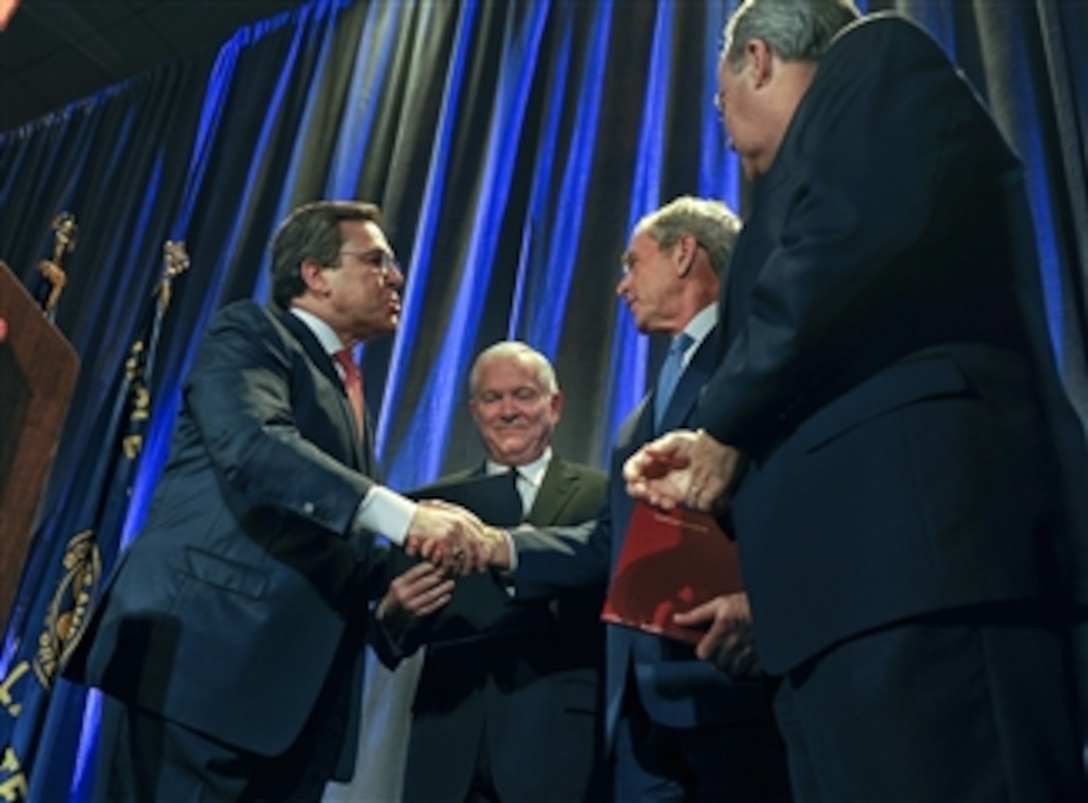 Former President of the United States George W. Bush and Secretary of Defense Robert M. Gates receive accolades during the Circle Ten Council Boy Scouts of America Friends of Scouting Dinner in Dallas, Texas, on March 3, 2011.  