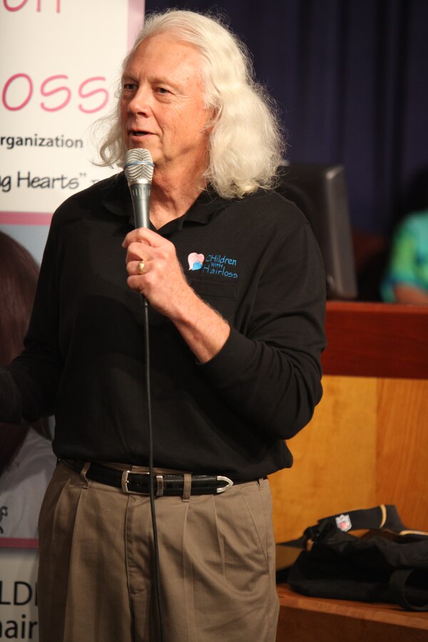 Retired Lt. Gen. Jack W. Bergman explains the personal rewards of continued service to others at the council chambers of city hall prior to getting his haircut and donated to a non-profit organization that provides wigs to children suffering from hair loss, March 4.