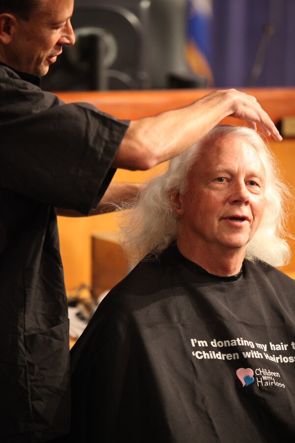 Eric “The Barber” Vandergriff prepares to take the first snip of retired Lt. Gen. Jack W. Bergman’s haircut in support of a non-profit organization that provides wigs to children suffering from hair loss, March 4.