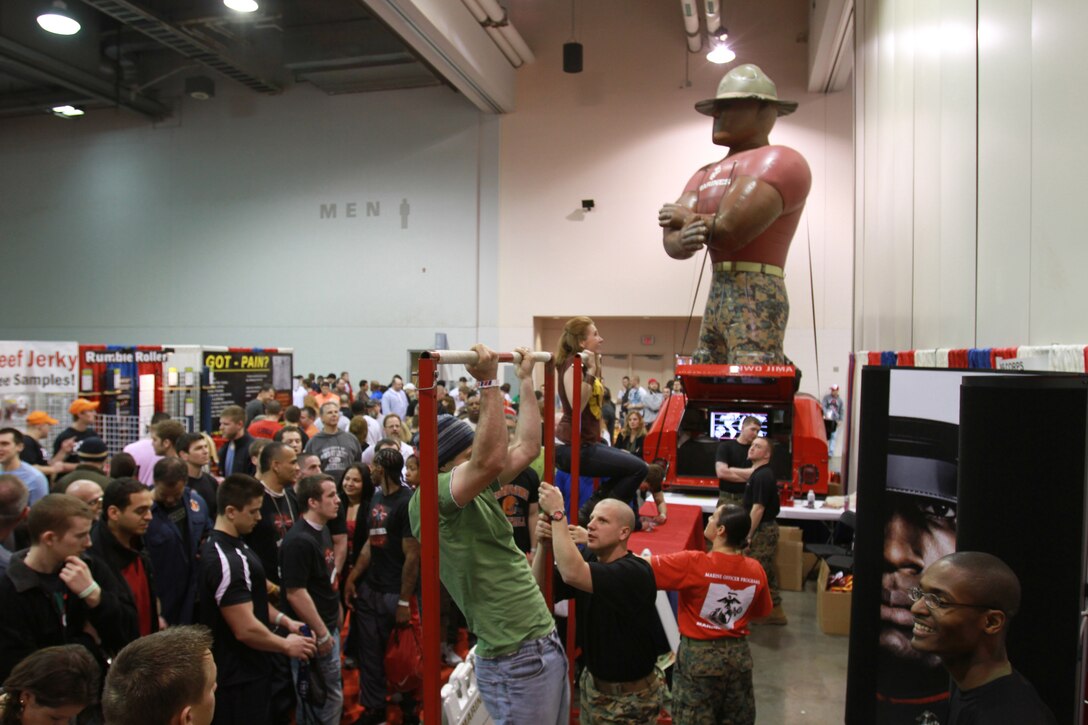 Lines gather in front of the Marine Corps pull-up challenge during the 2011 Arnold Sports Festival, March 5. Marine recruiters and officer selection officers from Recruiting Station Charleston, W.Va., monitored the pull-ups for the several hundred participants who attempted to obtain a prize. The four-day sports festival featured more than 40 sporting events throughout the Columbus area and is known as the largest multi-sport fitness weekend in the world. (Official U.S. Marine Corps photo by Sgt. Michael Stevens) (released)