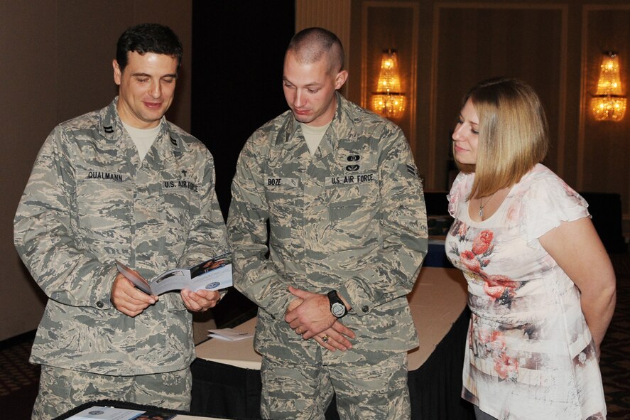 Chaplain Captain Lance Qualmann, speaks with Airman Joshua Boze, 131st Civil Engineering Squadron, and Rachel Boze, during the Yellow Ribbon Reintegration Program,  at the Millennium Hotel, Saint Louis, March 5.  The Secretary of Defense initiated the Yellow Ribbon Reintegration Program which provides information, services, referral, and proactive outreach programs to Guardsmen through all phases of the deployment cycle.  Yellow Ribbon representatives from Missouri National Guard Headquarters in Jefferson City, in conjunction with 131st Bomb Wing and local veteran representatives, hosted the day long event.   (Photo By Master Sergeant Mary-Dale Amison)