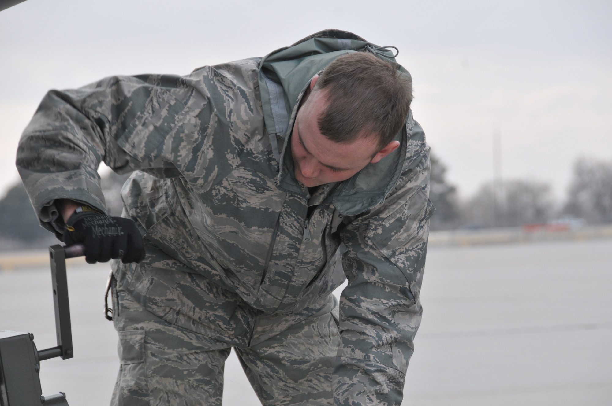 Staff Sgt. Adam Brannon, an aerospace maintainer with the 153rd Aircraft Maintenance Squadron, Wyoming Air National Guard, adjusts the towing bar attached to this WyANG C-130 on Feb. 24, 2011. The aircraft will undergo a transformation over the weekend, having all four of it's 8-blade propellors replaced with 4-blade systems. (USAF Photo by Master Sgt. Paul Mann)(Released)
