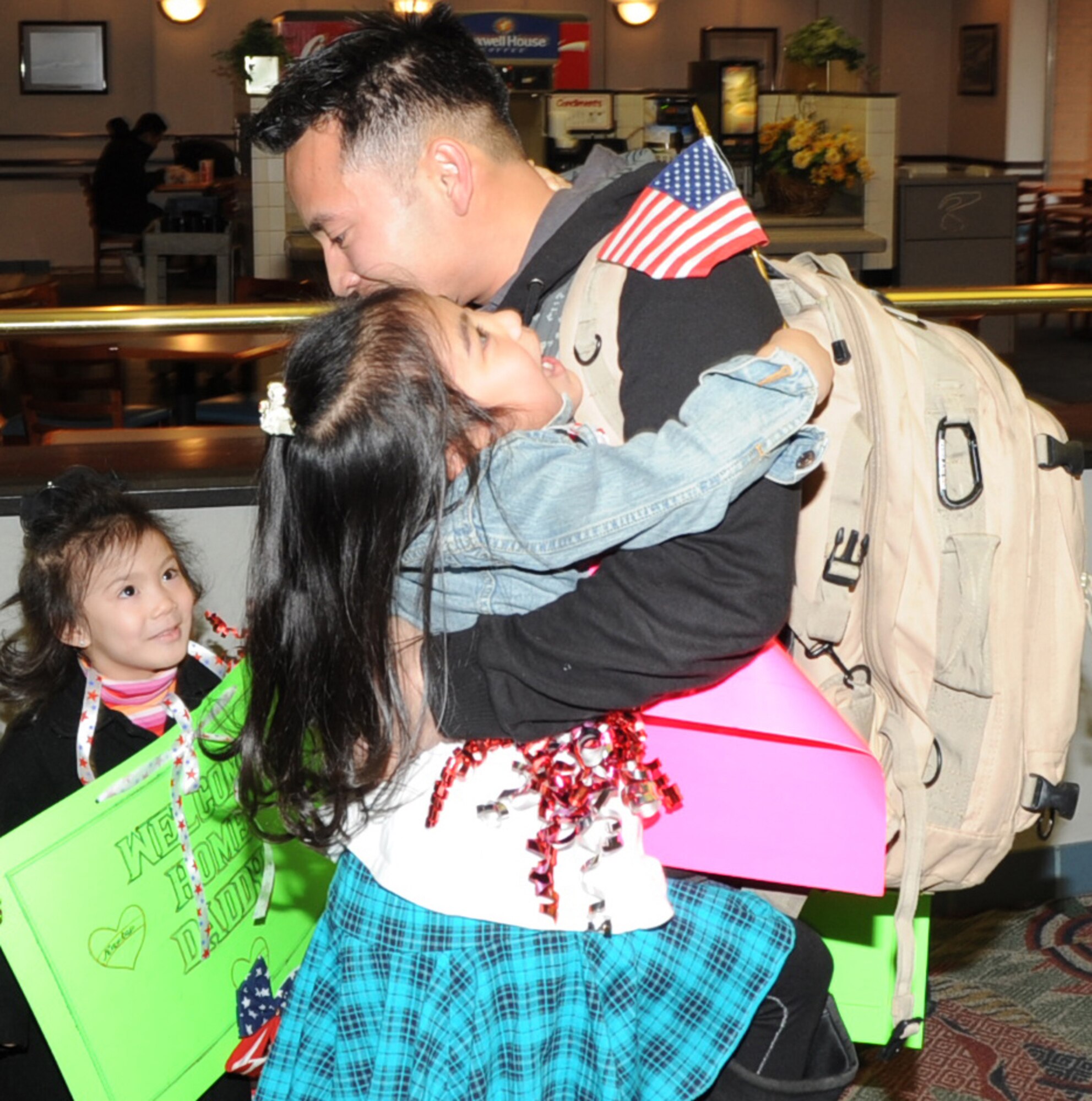Staff Sgt. Khoa Nguyen, a civil engineer from the 931st Air Refueling Group,
receives a hug from his daughter , Abigail, 6, and Kyla, 4, upon his arrival
at the Mid-Continent Airport in Wichita, March 4. Nguyen was one of 31 Air
Force Reserve members from the 931st Air Refueling Group who returned from a
six month deployment to Iraq and other parts of Southwest Asia in support of
Operation New Dawn. (Air Force photo by Tech. Sgt. Brannen Parrish)