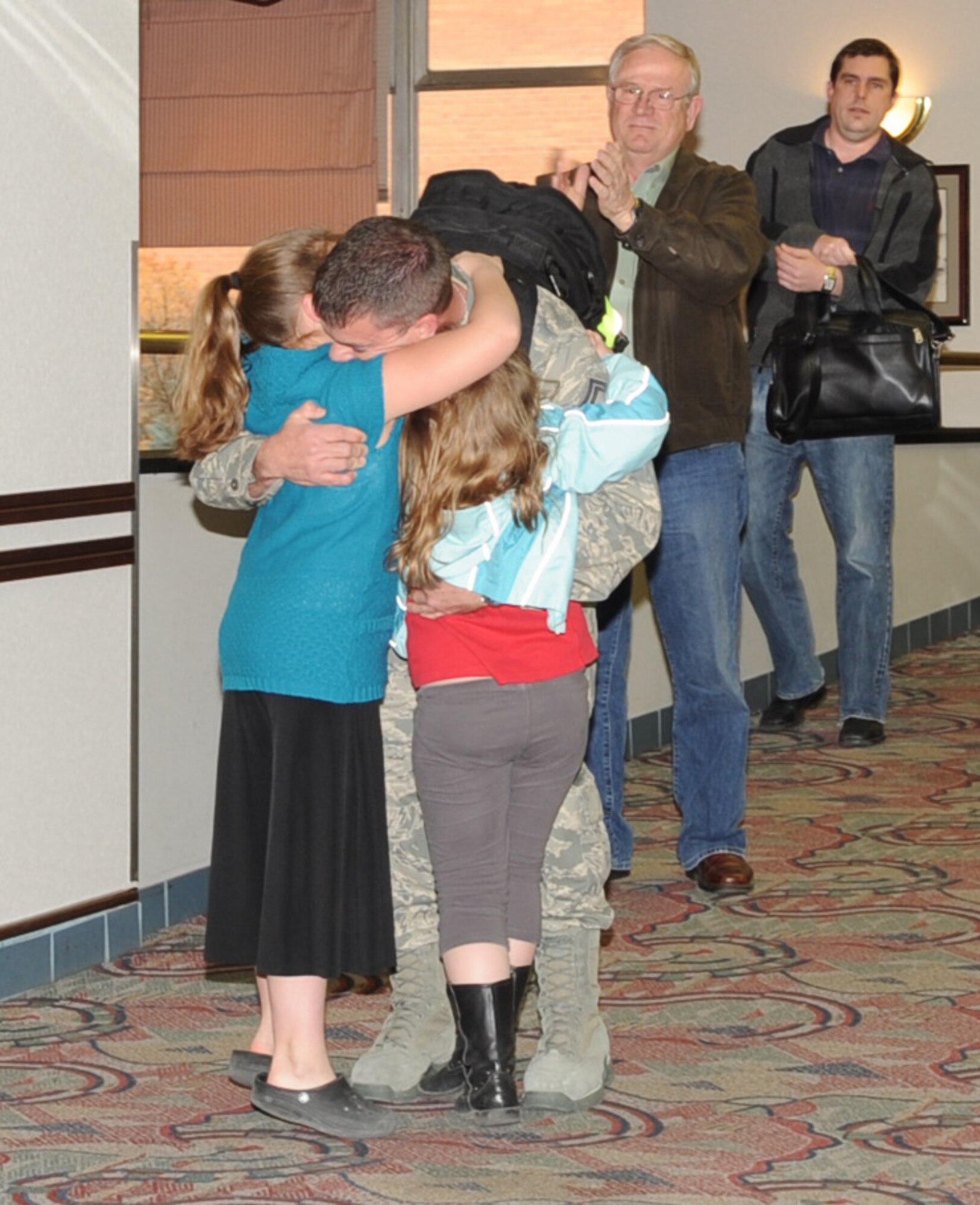 Senior Master Sgt. David Moore, a civil engineer from the 931st Air
Refueling Group, receives a hug from his daughters, Shianne and Lauren, upon
his arrival at the Mid-Continent Airport in Wichita, March 4. Sergeant Moore was one
of 31 Air Force Reserve members from the 931st Air Refueling Group
returning from a six month deployment to Iraq and other parts of Southwest
Asia in support of Operation New Dawn, Friday. (Air Force photo by Tech.
Sgt. Brannen Parrish)

