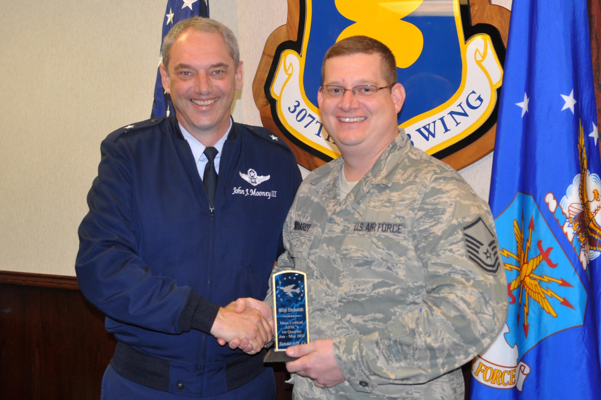 Brig. Gen. John J. Mooney III, commander, 307th Bomb Wing, and Master Sgt. Matthew Ehrhardt, line recruiter, 307th BW, pose for a photo during a Recruiter’s Quarterly Awards Ceremony at Barksdale Air Force Base, La., March 4, 2011. Sergeant Ehrhardt won the “Most Critical AFSC’s” award for the first quarter of 2011.