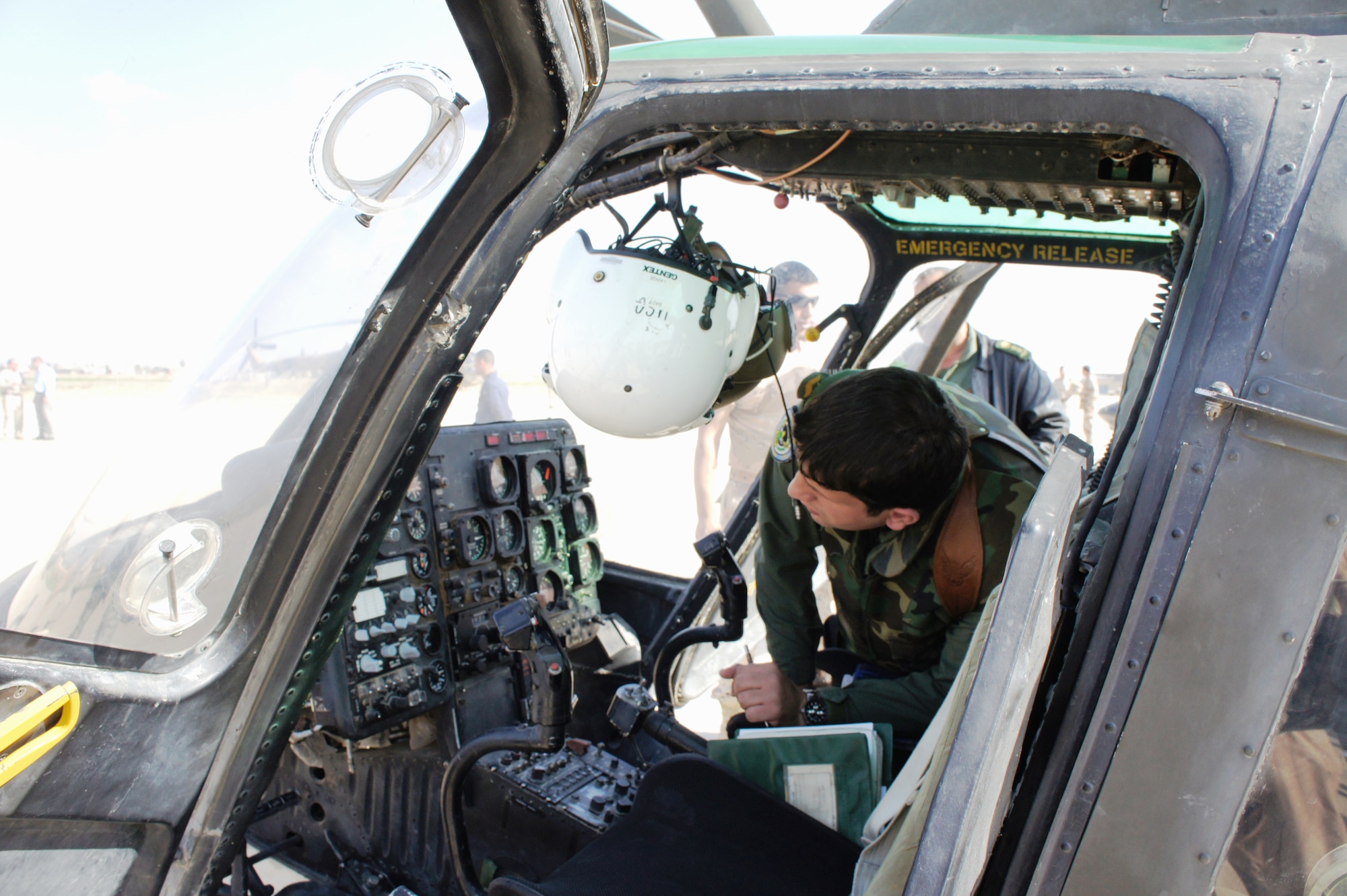 KIRKUK REGIONAL AIR BASE, Iraq – An Iraqi pilot conducts pre-flight checks on a Bell Jet Ranger helicopter for its final takeoff here March 1. The entire fleet of helicopters was transferred to Habbaniyah following the end of the flight-training contract between the Iraqi Army Aviation Command and the United States Army Security Assistance Training Management Organization. (Courtesy photo)