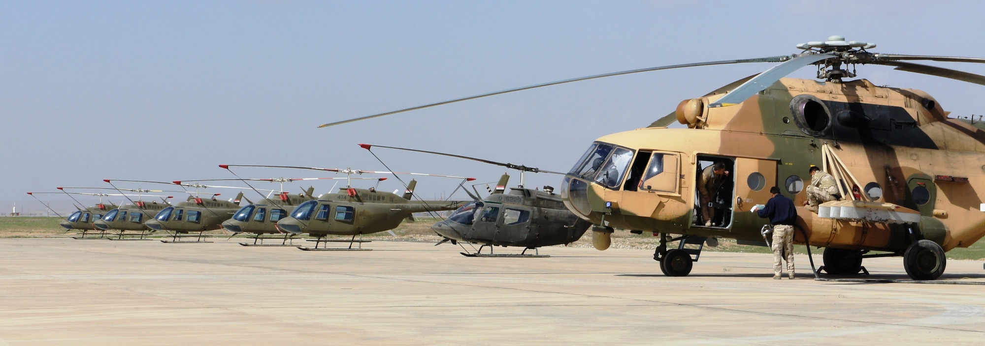 KIRKUK REGIONAL AIR BASE, Iraq – An Iraqi rotary-wing aircrew prepares an Mi-17 helicopter for its final takeoff here March 1.  The entire fleet of helicopters was transferred to Habbaniyah following the end of the flight-training contract between the Iraqi Army Aviation Command and the United States Army Security Assistance Training Management Organization. (Courtesy photo)
