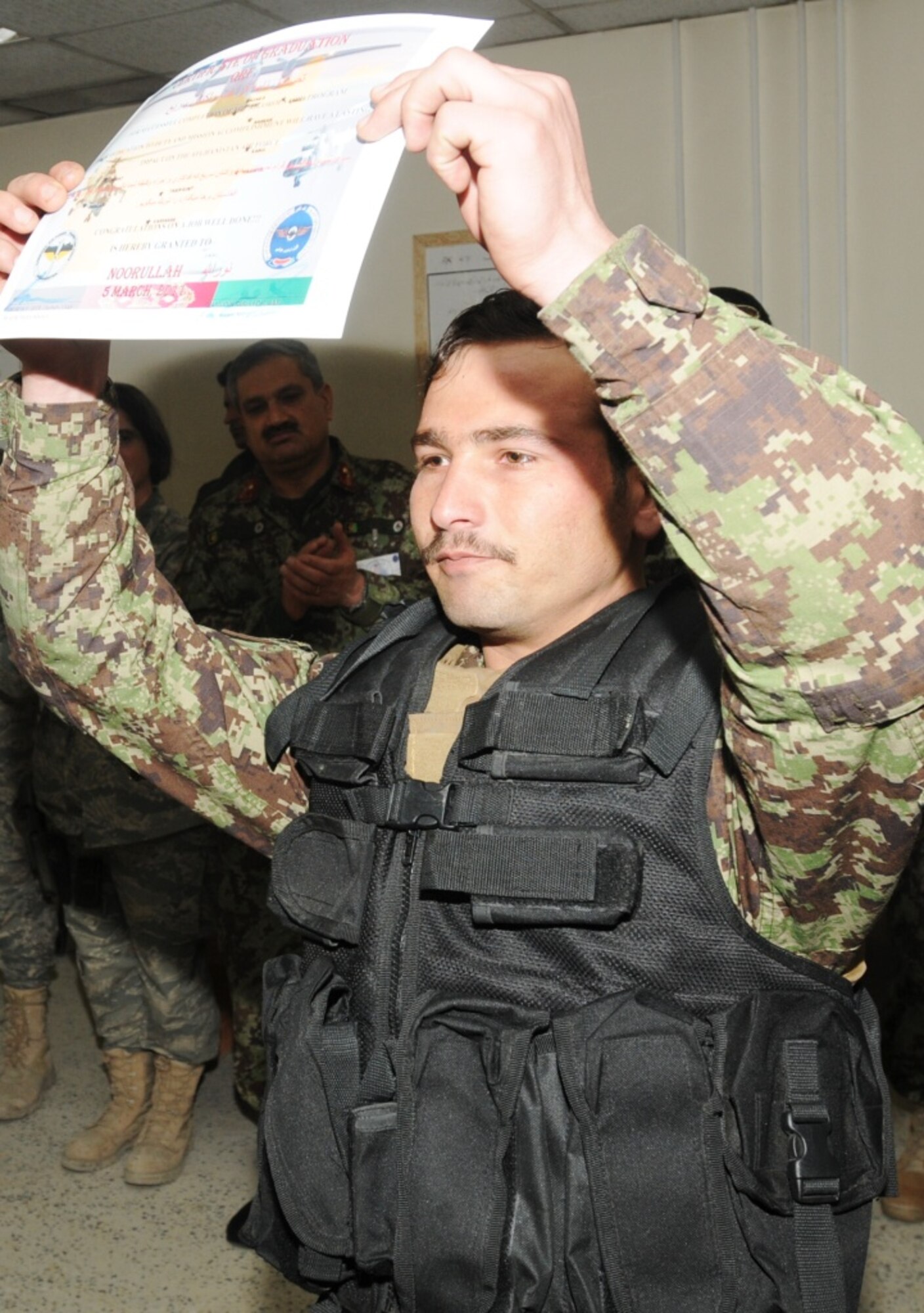 KABUL, Afghanistan - Twenty-five members of the Afghan Air Force, consisting of Airmen through Captain, graduated from the initial quick reaction force training course at the Afghan Air Force base at Kabul, Afghanistan, March 5. (U.S. Navy photo by Mass Communications Specialist 3rd Class Jared E. Walker)