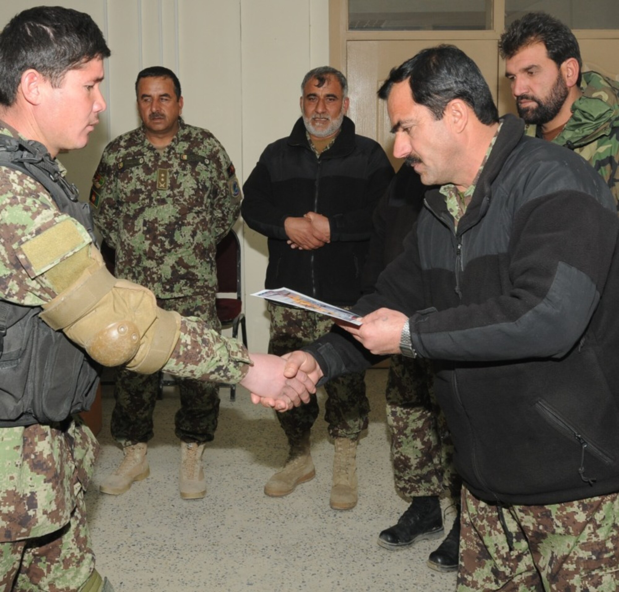 KABUL, Afghanistan - Twenty-five members of the Afghan Air Force, consisting of Airmen through Captain, graduated from the initial quick reaction force training course at the Afghan Air Force base at Kabul, Afghanistan, March 5. (U.S. Navy photo by Mass Communications Specialist 3rd Class Jared E. Walker)