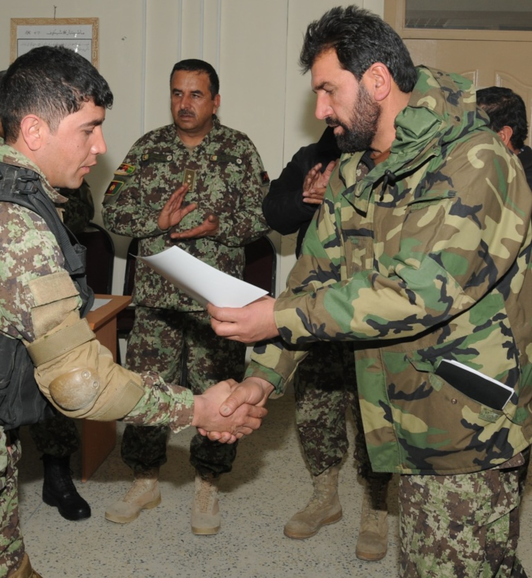 KABUL, Afghanistan - Twenty-five members of the Afghan Air Force, consisting of Airmen through Captain, graduated from the initial quick reaction force training course at the Afghan Air Force base at Kabul, Afghanistan, March 5. (U.S. Navy photo by Mass Communications Specialist 3rd Class Jared E. Walker)