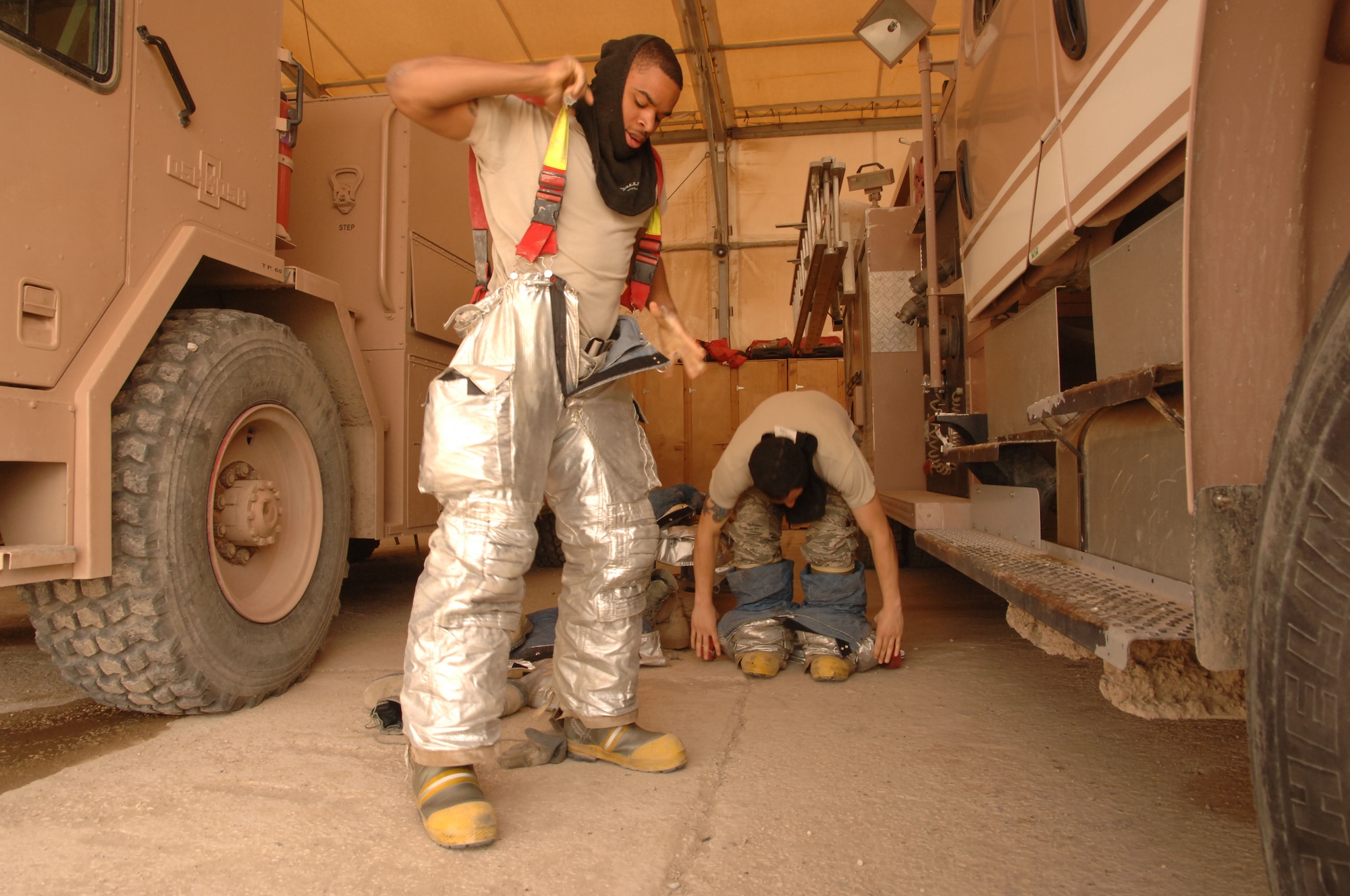 U.S. Air Force firefighters don their gear at the fire house on Ali Air Base, Iraq.