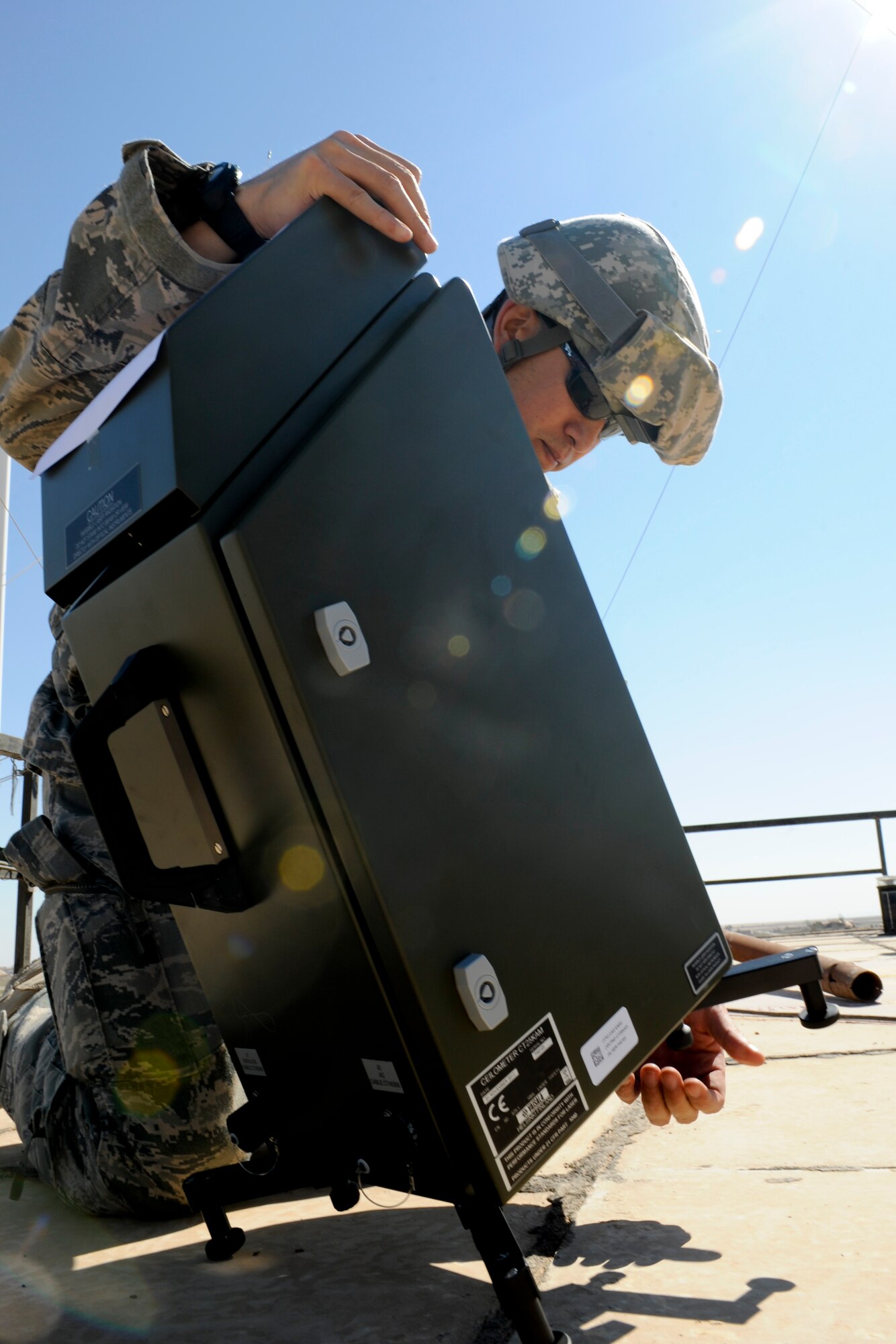 QAYYARAH WEST AIRFIELD, Iraq -- Master Sgt. Stephen Hale, 22nd Expeditionary Weather Squadron advising weather trainer, sets up part of a TMQ-53 weather observation system March 2. Sergeant Hale was part of a three-man weather team that traveled from Baghdad to retrieve U.S. Air Force equipment and install a newly purchased system as part of an ongoing process to set up a self-sustained Iraqi military weather service. Sergeant Hale is deployed from Detachment 2, 3rd Weather Squadron, Fort Riley, Kan., and is a native of San Antonio. (U.S. Air Force photo by Staff Sgt. Levi Riendeau)