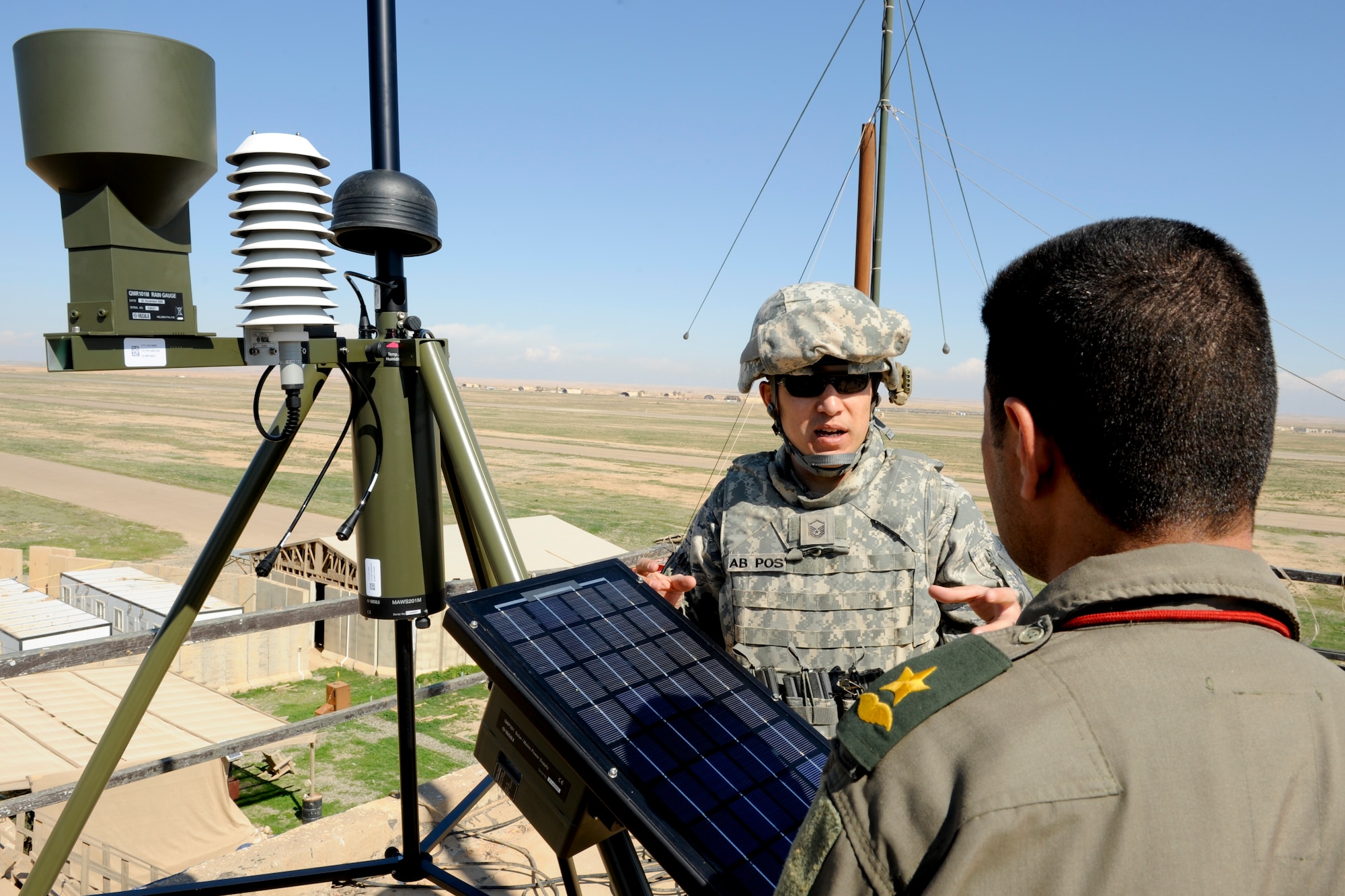 QAYYARAH WEST AIRFIELD, Iraq -- Master Sgt. Stephen Hale, 22nd Expeditionary Weather Squadron advising weather trainer, discusses preventive maintenance on the TMQ-53 weather observation system with an Iraqi weatherman March 2. Sergeant Hale was part of a three-man weather team that traveled from Baghdad to retrieve U.S. Air Force equipment and install a newly purchased system as part of an ongoing process to set up a self-sustained Iraqi military weather service. Sergeant Hale is deployed from Detachment 2, 3rd Weather Squadron, Fort Riley, Kan., and is a native of San Antonio. (U.S. Air Force photo by Staff Sgt. Levi Riendeau)
