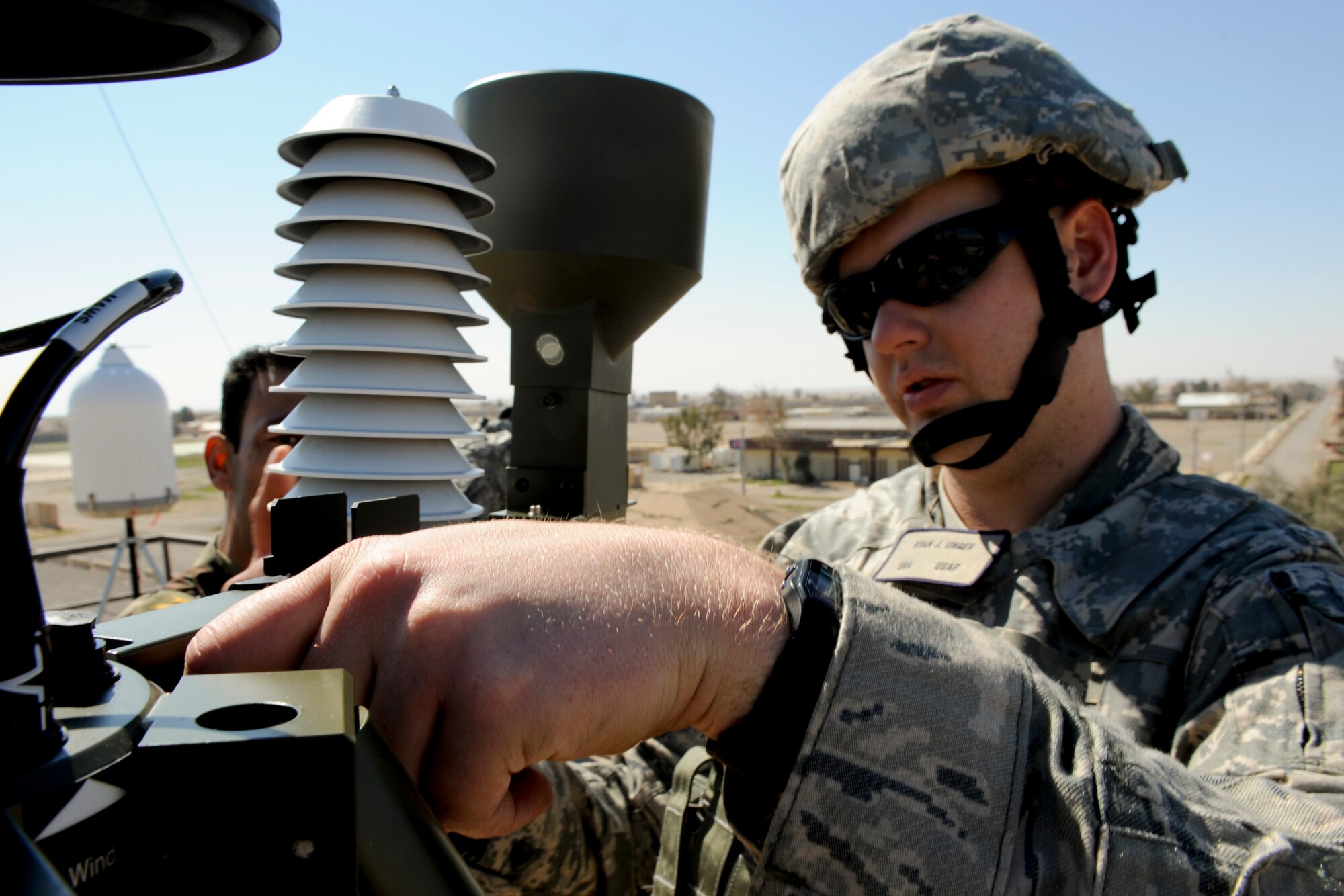 QAYYARAH WEST AIRFIELD, Iraq -- Senior Airman Ryan Unger, 22nd Expeditionary Weather Squadron weather technician, installs a TMQ-53 weather observation system March 2. Airman Unger was part of a three-man weather team that traveled from Baghdad to retrieve U.S. Air Force equipment and install a newly purchased system as part of an ongoing process to set up a self-sustained Iraqi military weather service. Airman Unger is deployed from the 2nd Combat Weather Systems Squadron, Hurlburt Field, Fla., and is a native of Thousand Oaks, Calif. (U.S. Air Force photo by Staff Sgt. Levi Riendeau)