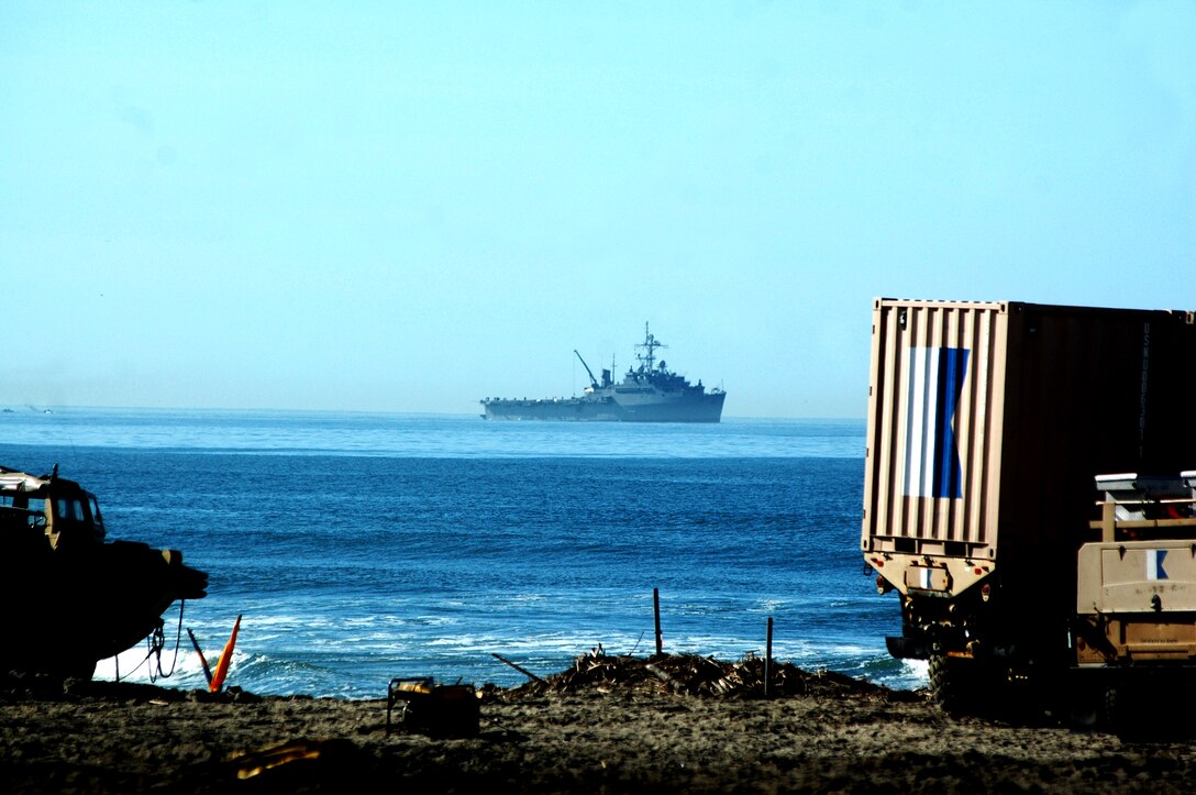 The USS Dubuque, (LPD-8), an Austin-class amphibious transport dock, sits off shore after unloading amphibious assault vehicles and other gear during exercise Pacific Horizon 2011.