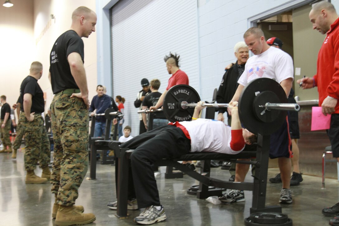 Sgt. Matthew Grogan, a recruiter with Recruiting Sub-Station South Columbus, Recruiting Station Charleston, W.Va., monitors a participant of the Arnold 5k Pump and Run here, March 6. Coordinators for the event selected Marines as judges of the bench-press portion of the pump and run because they are fair and equitable to each participant. The Arnold Sports Festival is an annual event, which features more than 40 sports over a multi-day period, throughout the Columbus area. (Official U.S. Marine Corps photo by Sgt. Michael Stevens) (released)