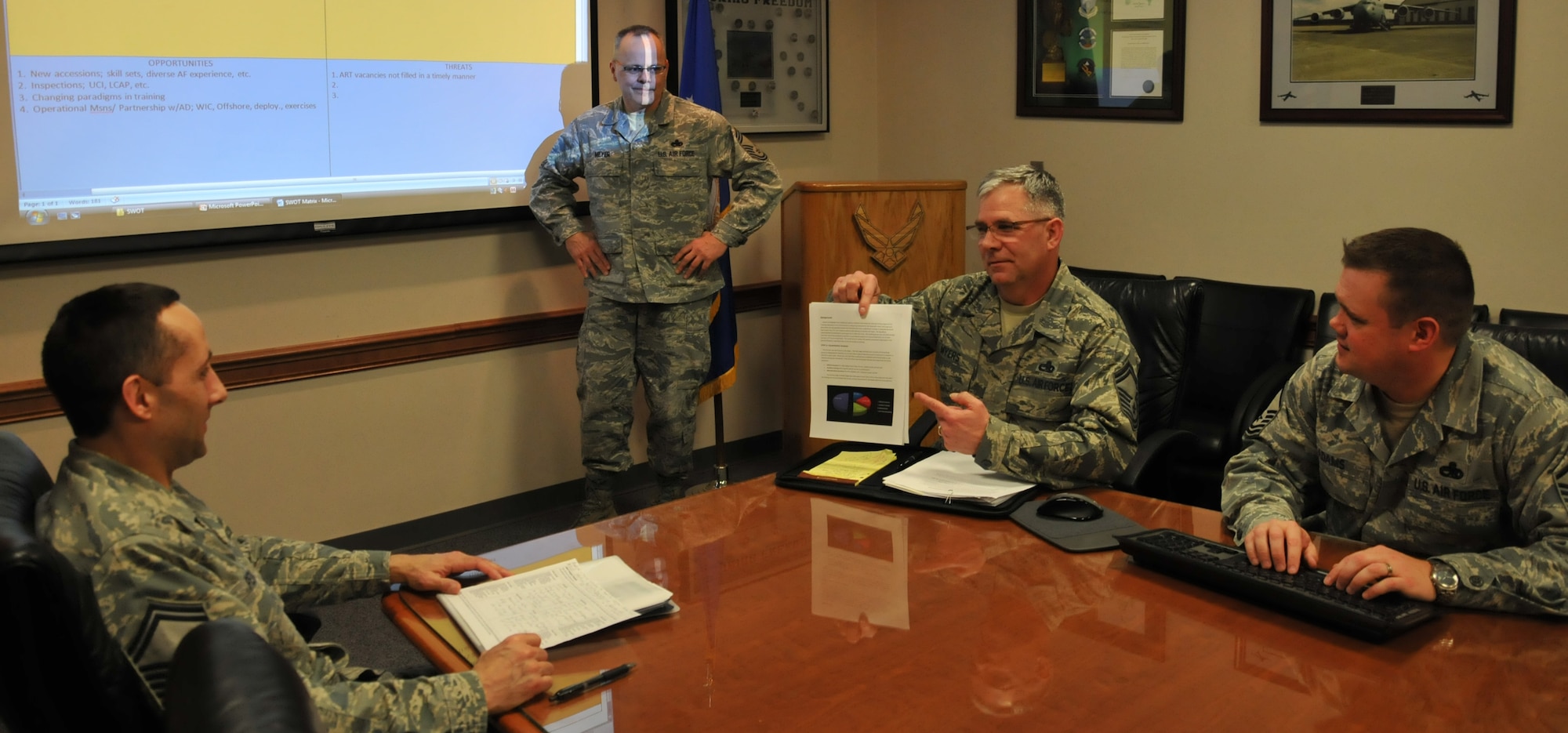 (Seated, left to right) Senior Master Sgt. Cameron Pence, Senior Master Sgt. Ralph Myers, and Master Sgt. John Adams, discuss the results of their aircraft maintenance S.W.O.T. analysis as Chief Master Sgt. Tim Meyer, 446th AMXS squadron superintendent, looks on. The senior NCOs are part of a working group assigned to allocate more aircraft training time for Traditional Reservists on UTA weekends, applying the business plan's principles of strategic planning to address their organization's future needs. (U.S. Air Force photo by Staff Sgt. Nicole Celestine/Released)