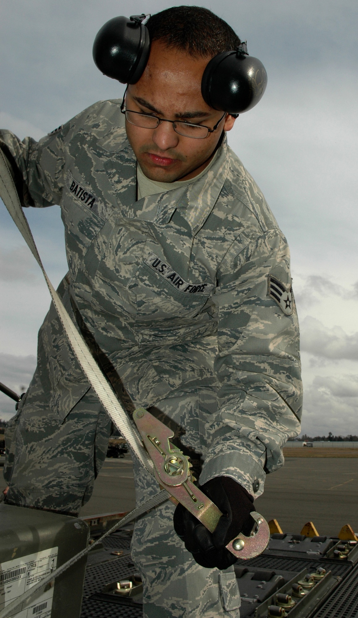 Senior Airman Wilfredo Batista, an air transportation journeyman with the 86th Aerial Port Squadron, McChord Field, Wash., fastens a simulated casket aboard a Next Generation Small Loader (NGSL) during the squadron's monthly training scenario, March 5. The latest training included collaboration with the 446th Force Support Squadron Services Sustainment Flight (U.S. Air Force photo by Staff Sgt. Nicole Celestine/Released)