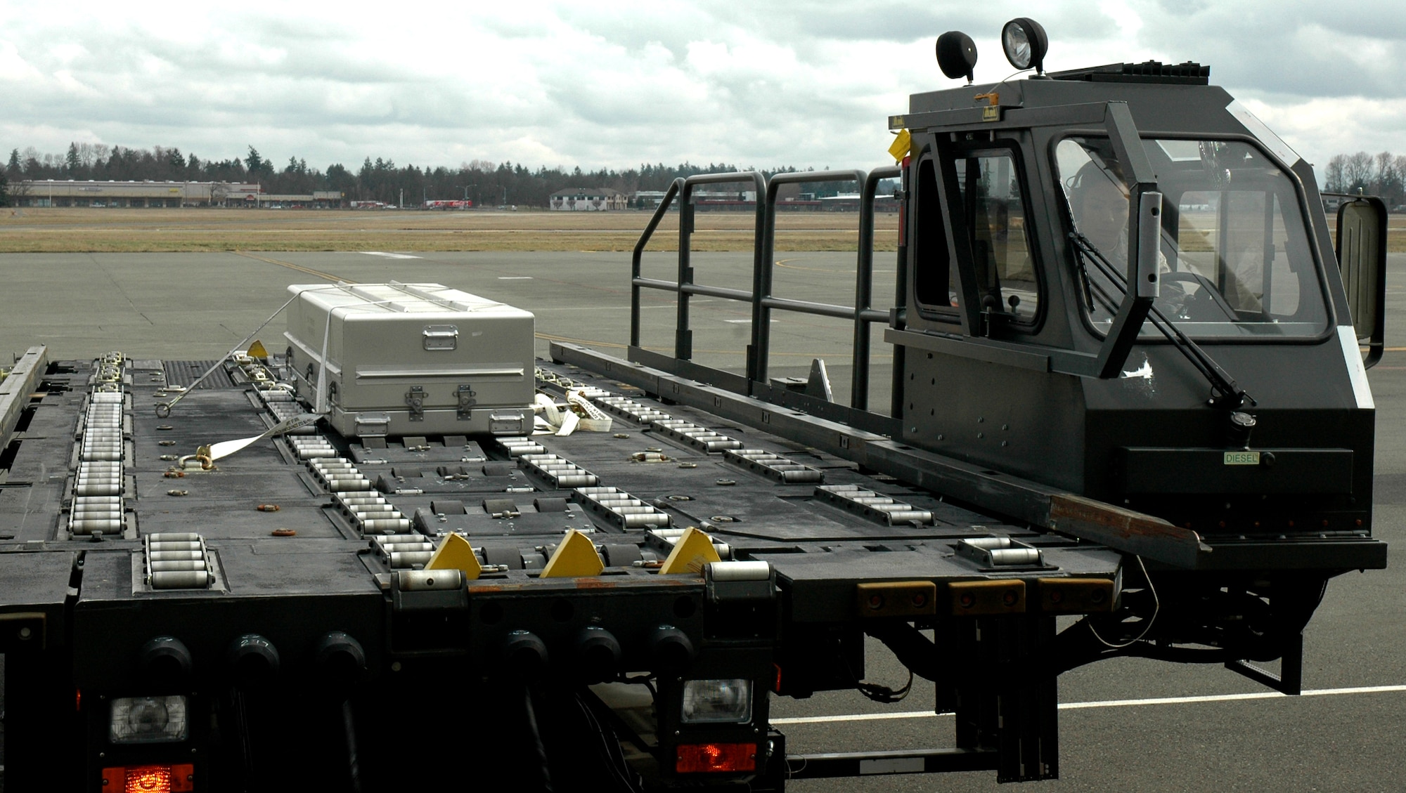 A trunk representing a simulated casket rests securely aboard a Next Generation Small Loader (NGSL), while being transferred from the loading area to a C-17 Globemaster III aircraft at McChord Field, Wash., during a joint training exercise between the 86th Aerial Port Squadron and 446th Force Support Squadron Services Sustainment Flight, March 5. Reservists within the units got a better understanding of each other's role and the overall dignified transfer process as a result of the training exercise. (U.S. Air Force photo by Staff Sgt. Nicole Celestine/Released)