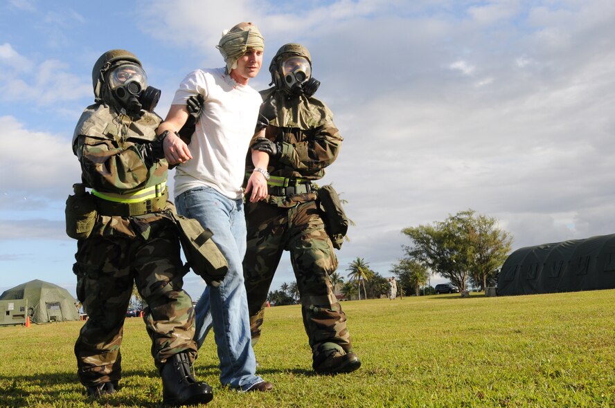 ANDERSEN AIR FORCE BASE, Guam - During Ability to Survive and Operate training (ATSO), Andersen Airmen escort a moulage victim to the medical tent to be treated, March 4. The ATSO training is part of the operational readiness exercise testing skills in hostage situations, bomb threats, and overall security procedures.(U.S. Air Force photo/ Senior Airman Carlin Leslie)