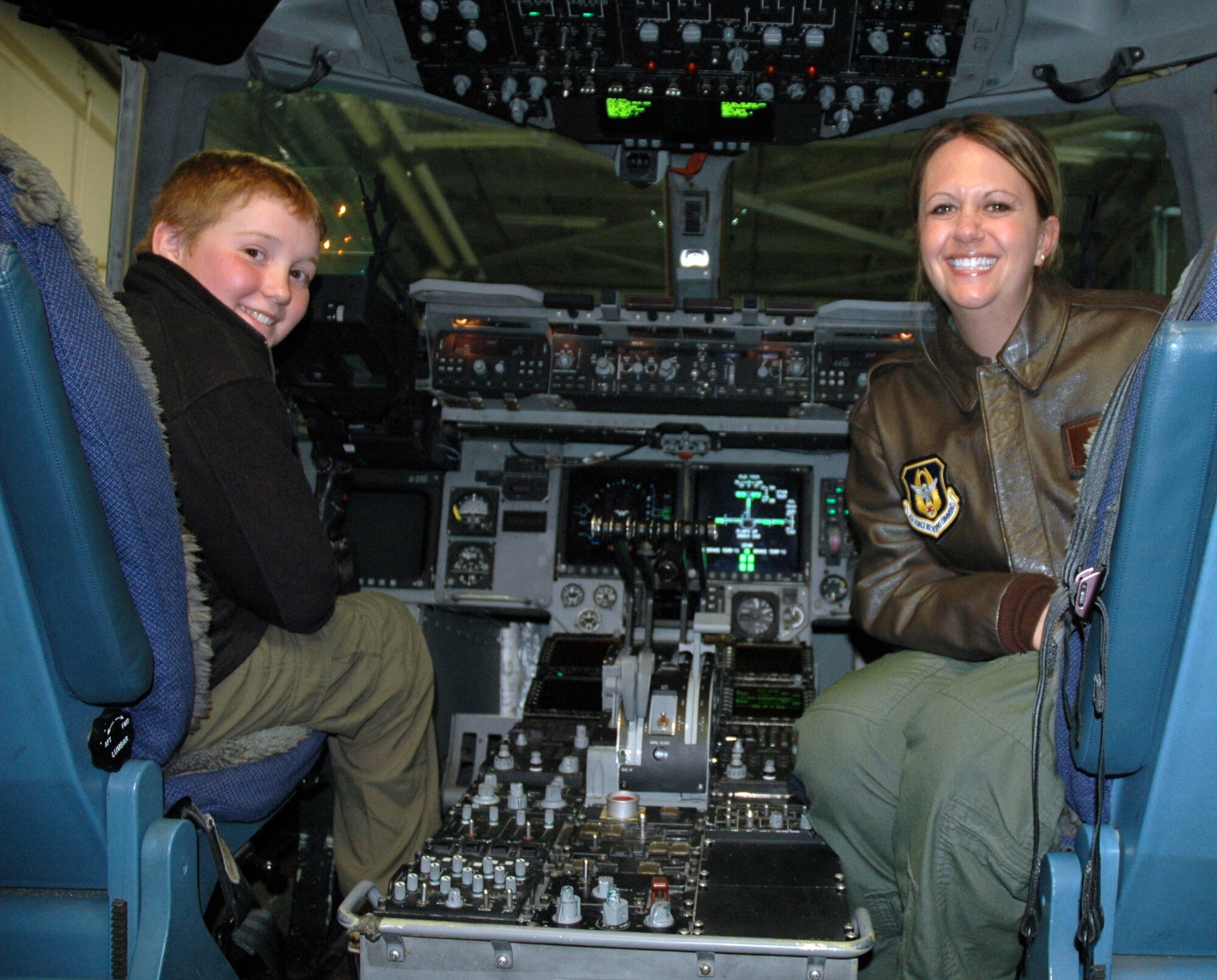 Boy Scout Caleb Cramer, age 11, dreams of piloting a C-17 Globemaster III with U.S. Air Force Captain Heather Van Maarth, 313th Airlift Squadron pilot here, March 5, 2011.  Three scout troops from Seattle and Redmond, Wash., spent the day hosted by the 446th Airlift Wing learning about the U.S. Air Force Reserve mission.  After their fun-filled day learning about fire safety, aeromedical evacuation, C-17 Globemaster III missions and air traffic control operations, the scouts heartily ate MREs for lunch before heading home. (U.S. Air Force photo by Staff Sgt. Elizabeth Moody/Released)