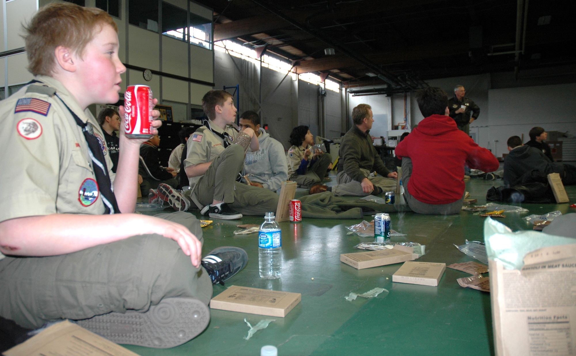 Boy Scouts wolf down their MREs during a fun-filled day with U.S. Air Force Reservists from the 446th Airlift Wing here, March 5, 2011.  Three Boy Scout troops from Seattle and Redmond, Wash., toured McChord Field learning about about air traffic control, caring for injured patients, fire safety and C-17 Globemaster III missions around the world.  (U.S. Air Force photo by Staff Sgt. Elizabeth Moody/Released)