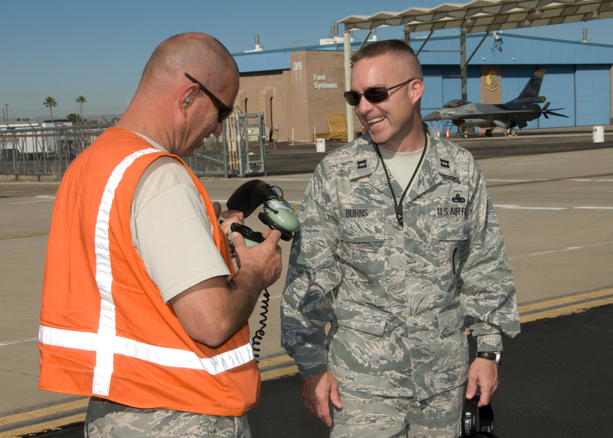 Capt. Jason Burns, a maintenance officer at the 162nd Fighter Wing, talks about maintenance issues on the flightline at Tucson International Airport. He is the Arizona Air National Guard’s outstanding junior officer for 2010. (U.S. Air Force photo/Master Sgt. Dave Neve)