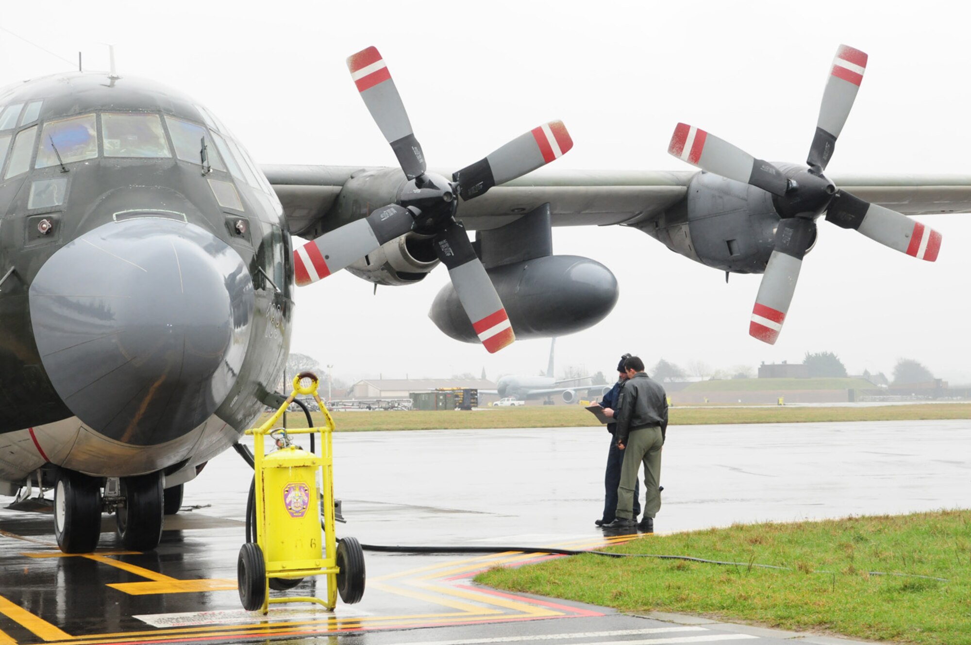 .RAF MILDENHALL, England -- Matt Bauer, aircraft servicer and contractor for 100th Maintenance Squadron Transient Alert, talks with a Turkish pilot as he goes through a checklist to ensure there are no problems with the aircraft which has just landed, and to verify if it needs refueling or maintenance. On average, TA works with three to four different countries' air forces per month, and see about 120 aircraft, including KC-135 Stratotankers from other U.S. bases, during that timeframe. (U.S. Air Force photo/Karen Abeyasekere)