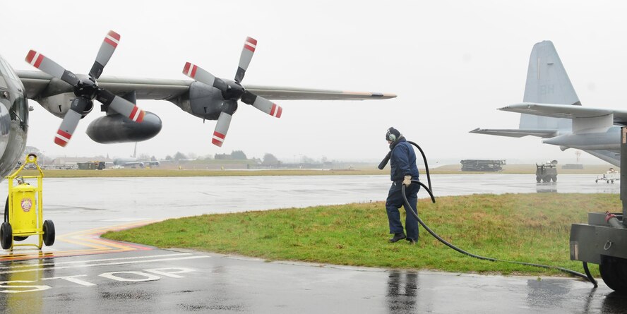 RAF MILDENHALL, England -- Matt Bauer, a contractor working for 100th Maintenance Squadron Transient Alert, prepares to hook up power to a Turkish C-130 which he had just led into its parking spot from the "Follow Me" truck recently. Transient Alert provides servicing and maintenance support for all aircraft transiting through RAF Mildenhall, including all NATO partners, most of which are from the United Kingdom, Germany, turkey, Netherlands and Belgium. (U.S. Air Force photo/Karen Abeyasekere)