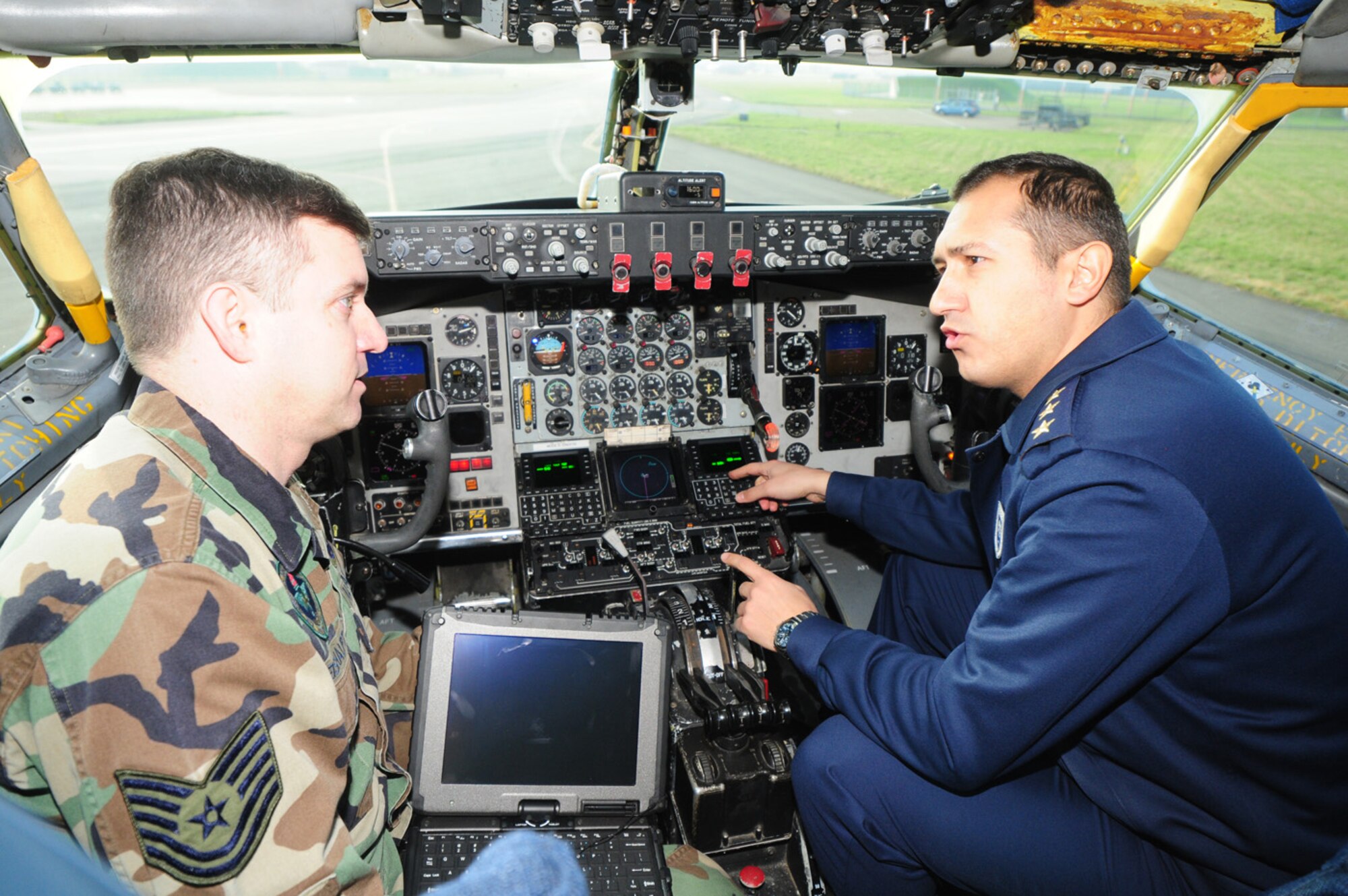 RAF MILDENHALL, England -- Tech. Sgt. Gary Weishaupt, 373rd Training Squadron, Detachment 19, communication navigation mission systems master instructor, answers questions from a captain in the Turkish Air Force March 2, 2011, in the cockpit of a KC-135 Stratotanker. Several Turkish Air Force and civilian members were here for a two-week course, learning about the Global Air Traffic Management avionics upgrade. The Turkish Air Force will receive their first upgraded jet within the next month. (U.S. Air Force photo/Karen Abeyasekere)