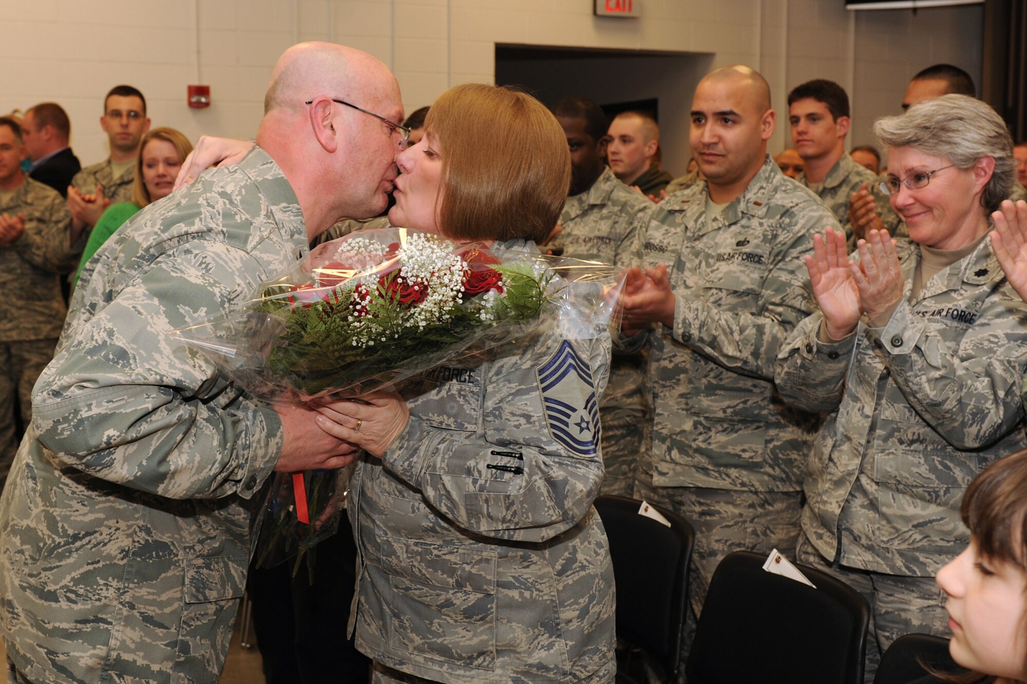 Outgoing 174th Fighter Wing Mission Support Group Commander Col. Harvey M. Van Wie, Jr. presents his wife Chief Master Sgt. Judy Van Wie with a bouquet of roses after he relinquished command of the MSG to incoming Commander Lt. Col. Earl A. Evans. Col. Van Wie has served in the military for more than 40 years and has been assigned as the Special Projects Project Officer for the 174FW. (USAF Photo by: Staff Sgt. James N. Faso II/ RELEASED)