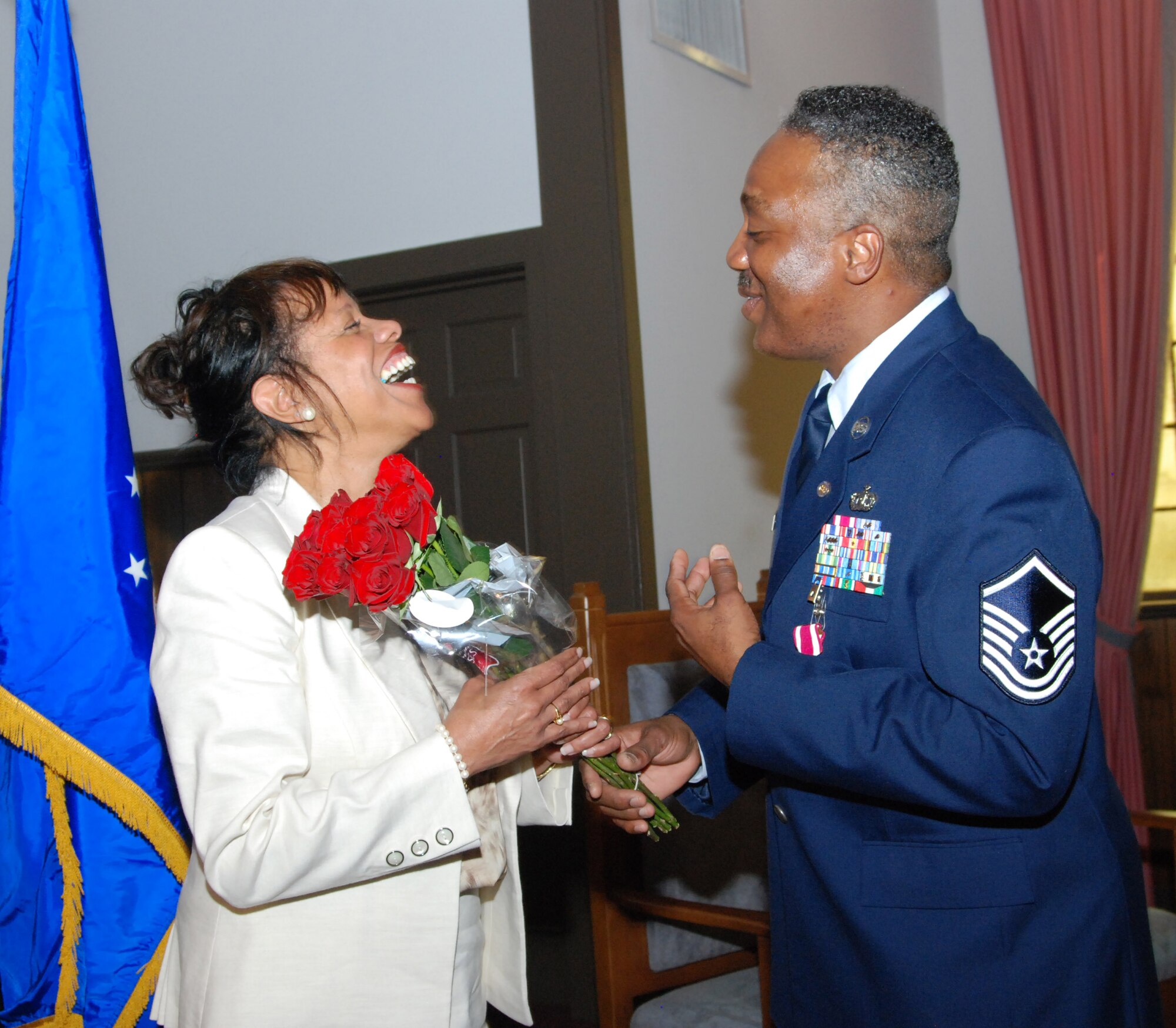 Master Sgt. Mike Varnado presents his wife Trudy with a bouquet of roses during his retirement ceremony during the 94th Airlift Wing's March UTA.  Sergeant Varnado is retiring with 36 years of service to the Air Force.  (U.S. Air Force photo/Master Sgt. Stan Coleman)