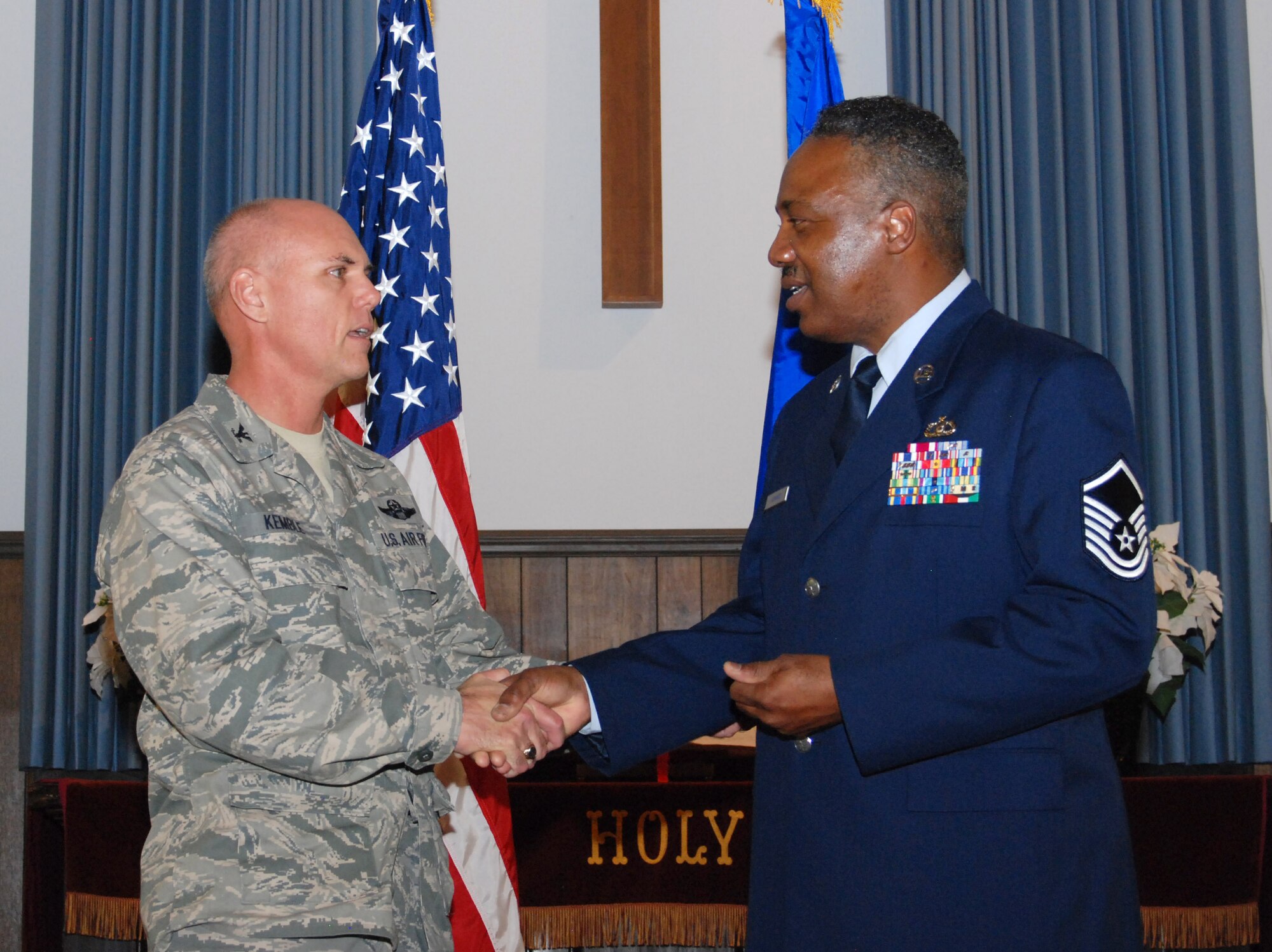 Col. Richard Kemble, 94th Airlift Wing vice commander, presents Master Sgt. Mike Varnado with a coin for his service during Sergeant Varnado’s retirement ceremony March 5.  Sergeant Varnado, 94th Operations Life Support assistant NCOIC is retiring after 36 years of service to the United States Air Force and Air Force Reserve. (U.S. Air Force photo/Master Sgt. Stan Coleman)