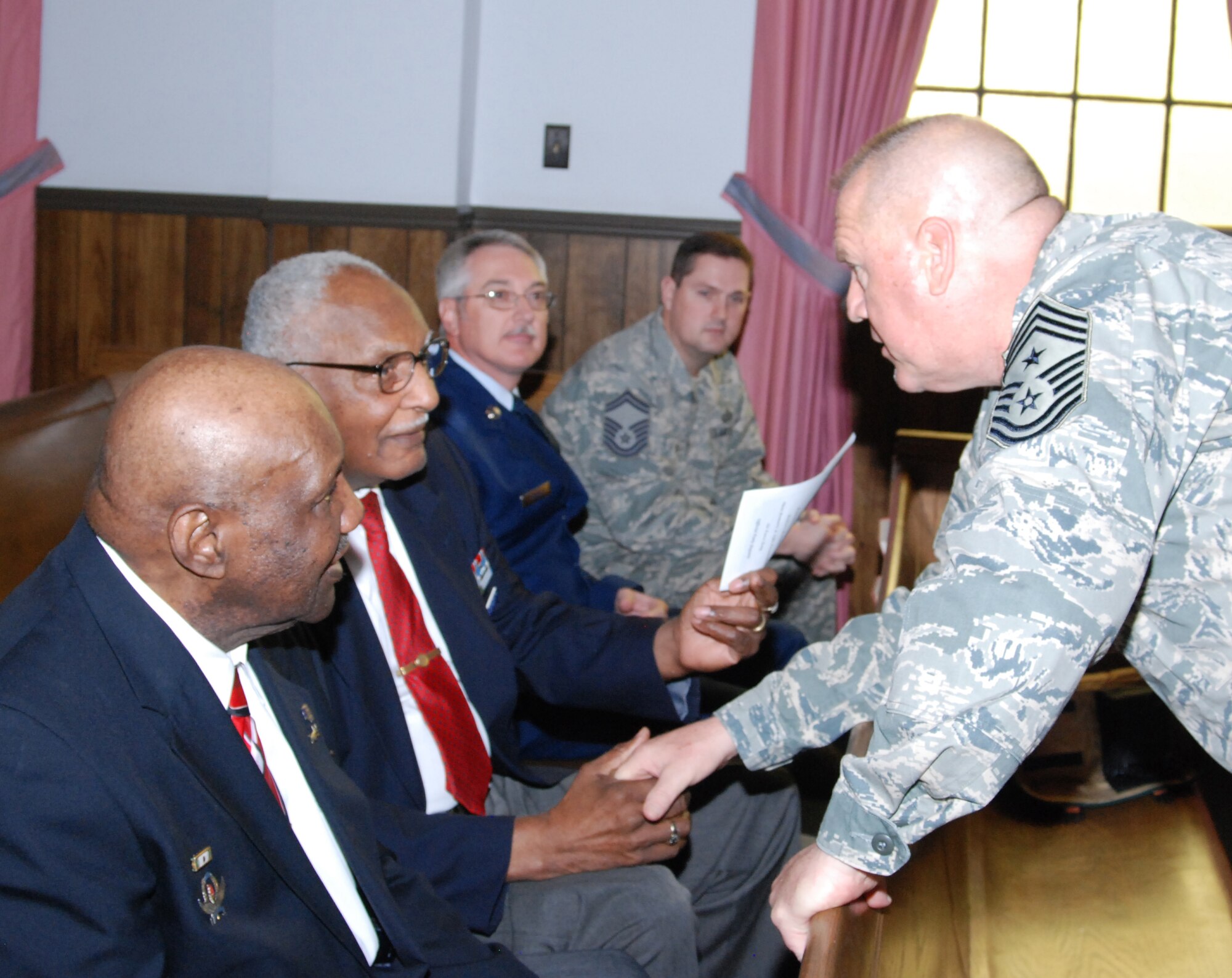 94th Airlift Wing Command Chief Master Sgt. John Anderson greets Chief Master Sgt. (retired) Donald Summerlin  prior to the retirement ceremony of Master Sgt. Mike Varnado March 5.  Mr. Summerlin is a member of the Atlanta Chapter Tuskegee Airmen and was assigned to the 94th AW more than 20 years ago. (U.S. Air Force photo/Master Sgt. Stan Coleman)