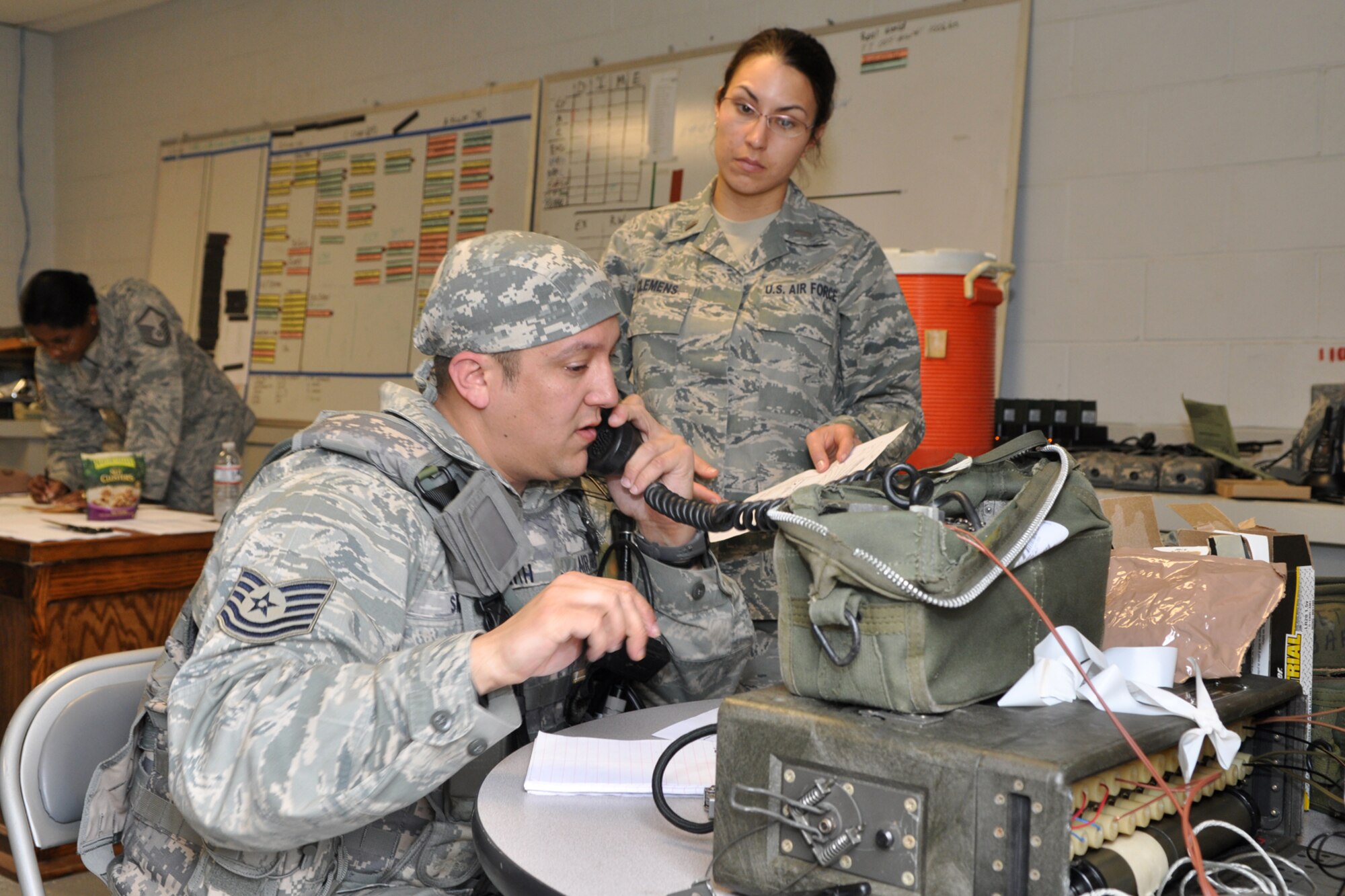 Technical Sgt. Charles Smith, operations management specialist, and 2nd Lt. Chelsea Clemens, logistics readiness officer, check range cards with the Airmen stationed at defensive fighting positions (DFP) around the RED HORSE Squadron compound on Barksdale Air Force Base, La., March 4, 2011. Sergeant Smith and Lieutenant Clemens are assigned to the RED HORSE Squadron at Barksdale AFB. They are participating in an exercise that is simulating a deployment to a Southwest Asia location where the Airmen are building helicopter landing pads for a U.S. Marine Unit. (U.S. Air Force photo/Tech. Sgt. Jeff Walston)
