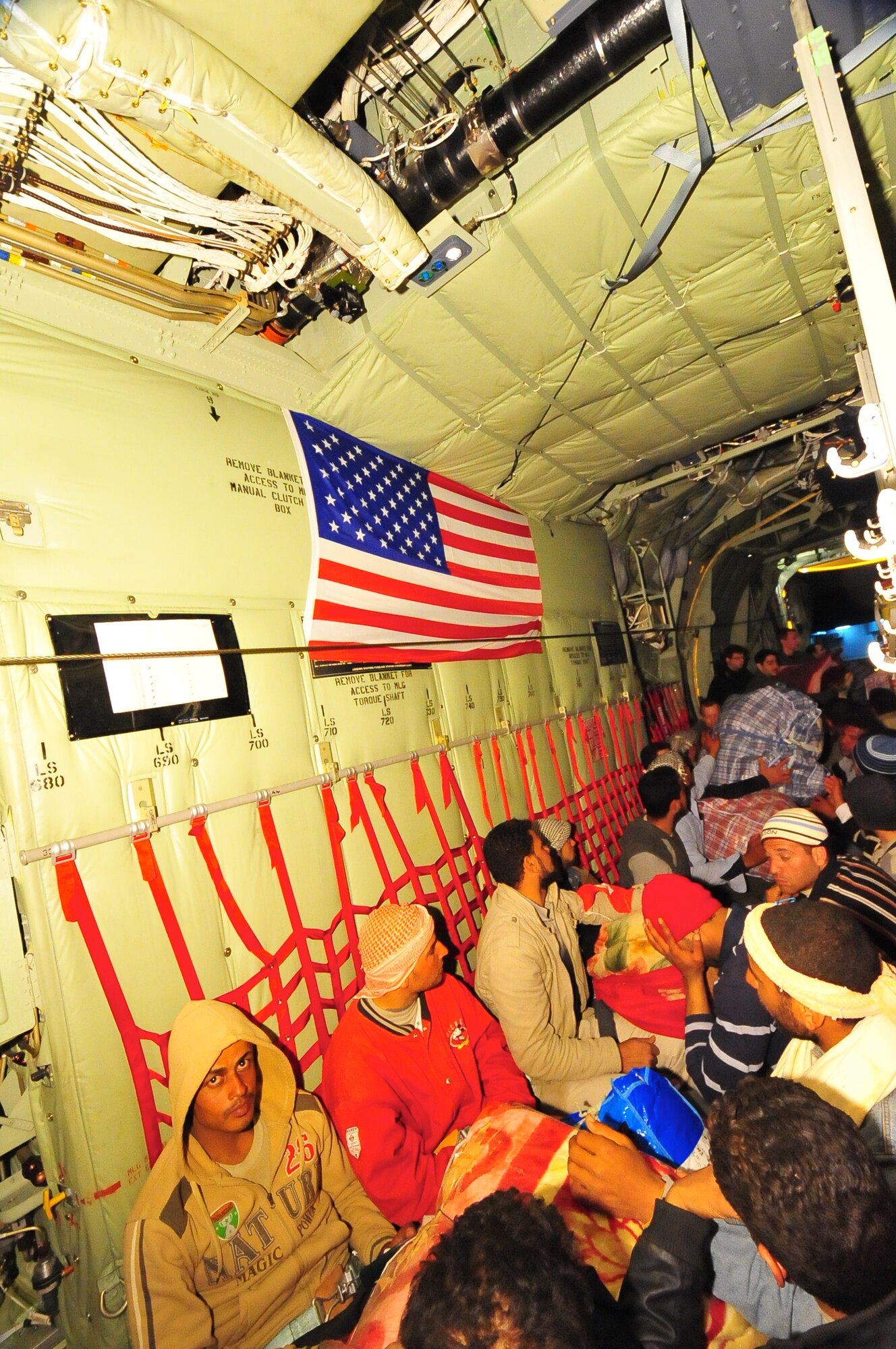 Displaced Egyptian citizens who have fled to Tunisia from violence and instability in Libya are transported aboard a U.S. Air Force C-130J from Djerba, Tunisia to Cairo, Egypt March 5, 2011. This response to the developing humanitarian crisis is part of a broader U.S. government effort to relieve suffering caused by the crisis the in Libya. (U.S. Army photo by Staff Sgt. Brendan Stephens) 
