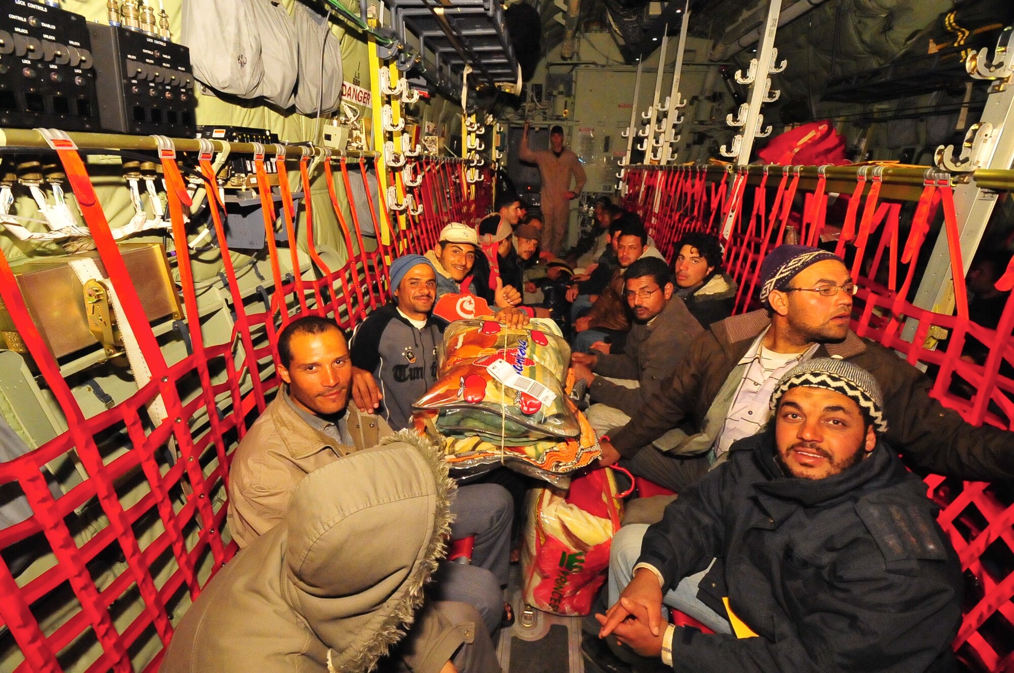 Displaced Egyptian citizens who have fled to Tunisia from violence and instability in Libya are transported aboard a U.S. Air Force C-130J from Djerba, Tunisia to Cairo, Egypt March 5, 2011. This response to the developing humanitarian crisis is part of a broader U.S. government effort to relieve suffering caused by the crisis the in Libya. (U.S. Army photo by Staff Sgt. Brendan Stephens)




