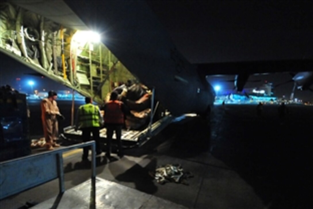 A U.S. Air Force C-130J aircraft carrying Egyptian refugees arrives at Cairo's International Airport, in Egypt, March 6, 2011. This is the first of many scheduled flights from Djerba, Tunisia, to Cairo, Egypt. The U.S. government is working with the international community to meet the humanitarian needs of the Libyan people and others in their country who fled across the border because of political unrest. 