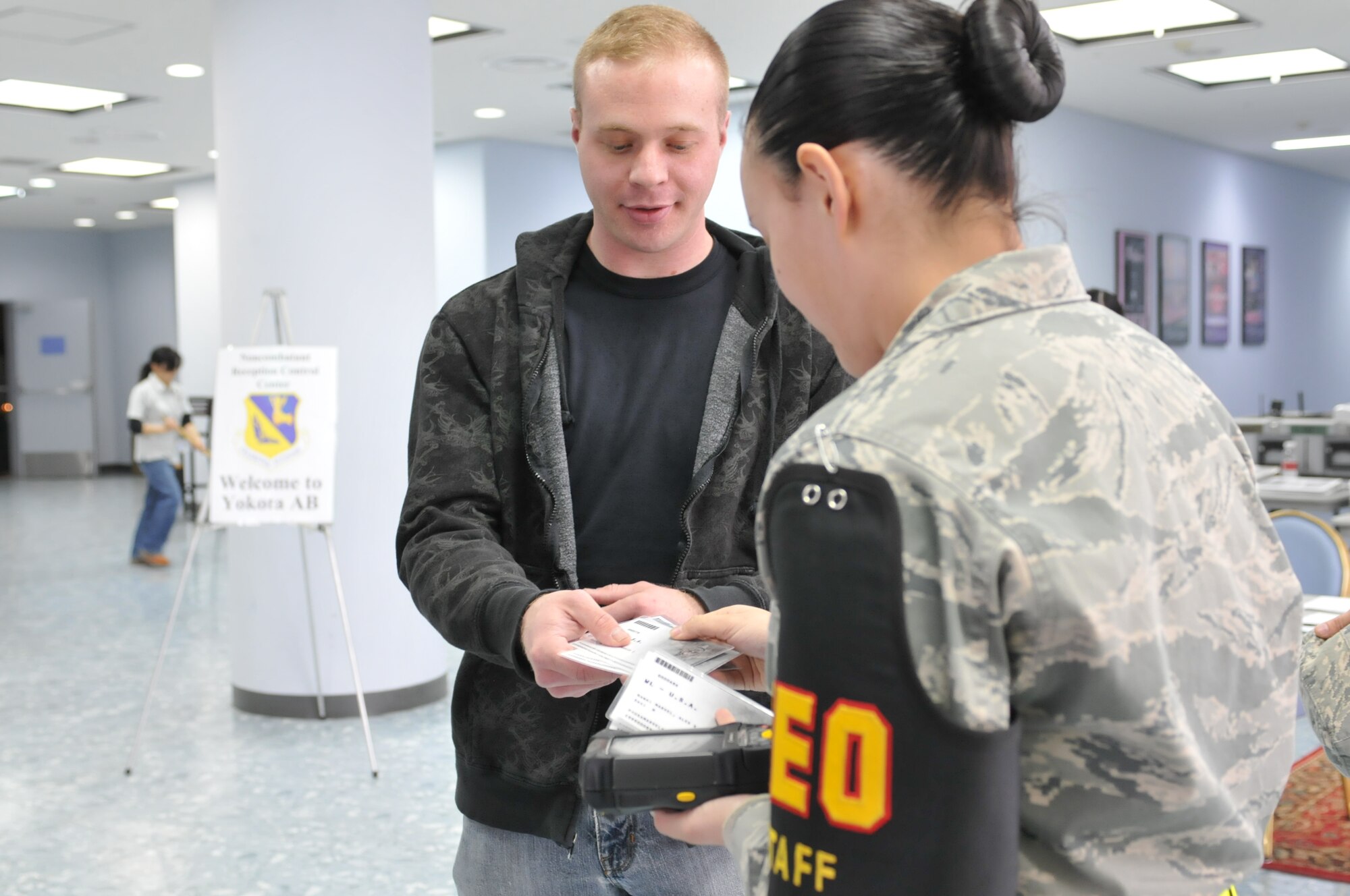 YOKOTA AIR BASE, Japan -- Individuals process through a Noncombatant Evacuation Operations facility during an Operational Readiness Exercise here March 7. Noncombatants are evacuated and relocated during times of war, political and civil instability, and natural disasters. (U.S. Air Force photo/Airman 1st Class Krystal M. Garrett)