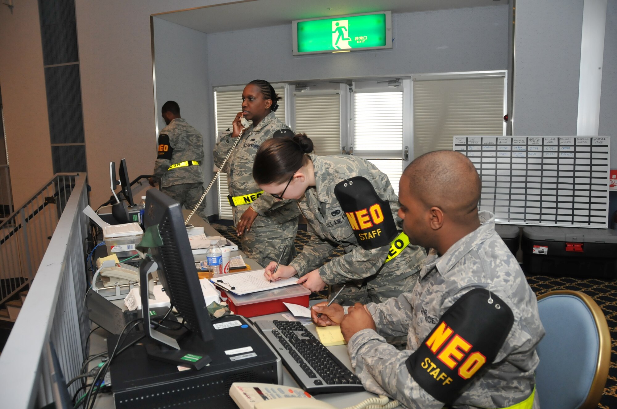 YOKOTA AIR BASE, Japan -- Noncombatant Evacuation Operations command and control center staff members coordinate the reception and transit of simulated noncombatants during an Operational Readiness Exercise here March 7. NEO occurs during a time of war, political and civil instability, and natural disasters. (U.S. Air Force photo/Airman 1st Class Krystal M. Garrett)