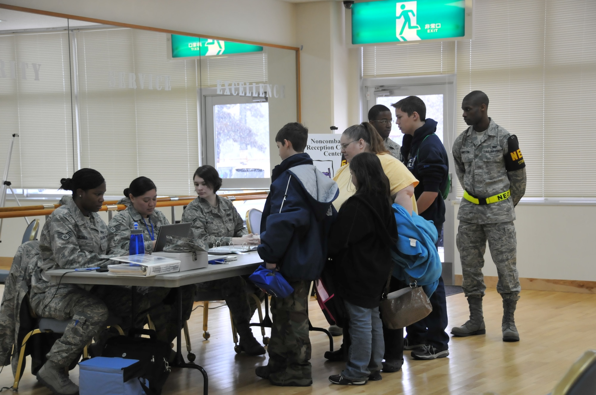 YOKOTA AIR BASE, Japan -- Staff Sgt. Tammera Jones, 374th Force Support Squadron, along with Staff Sgt. Tori Hawkins and Airman 1st Class Kayla McCabe, members from the 374th Civil Engineer Squadron, process members participating in  Noncombatant Evacuation Operations during an Operational Readiness Exercise here, March 7. (U.S. Air Force photo/Airman 1st Class Krystal M. Garrett)