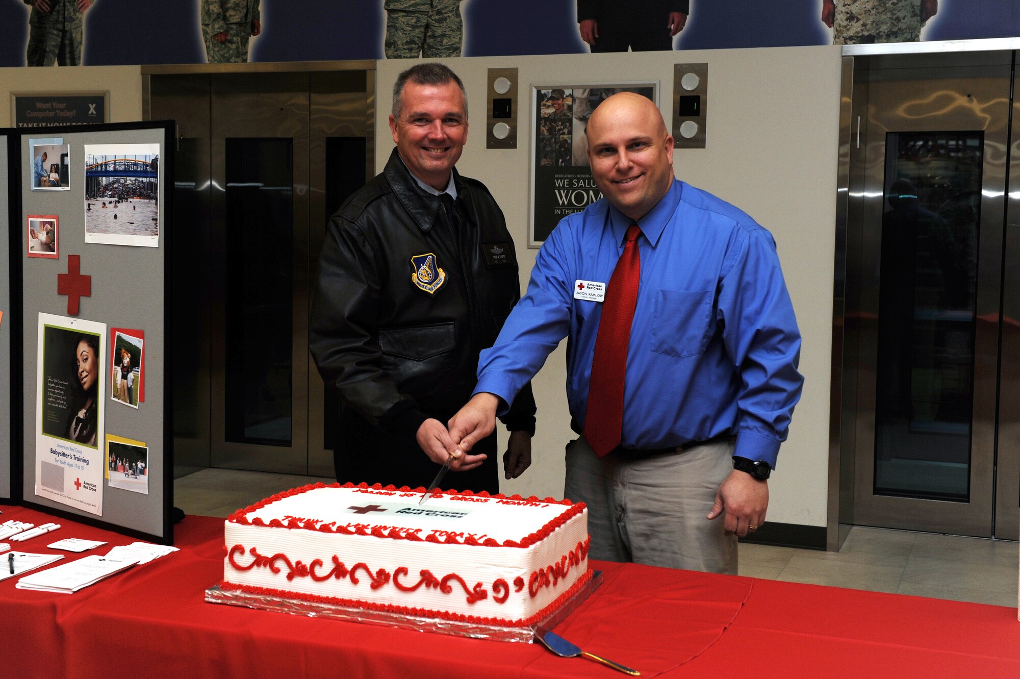 Col. Ricky Rupp, 18th Wing vice commander, and Mr. Jason Ramlow, station manager from the American Red Cross, cut a cake in celebration of Red Cross Month at the base exchange on Kadena Air Base, March 7.  In 2010 the American Red Cross volunteers dedicated more than 16,200 hours of service to the Kadena community. (U.S. Air Force photo/Junko Kinjo)