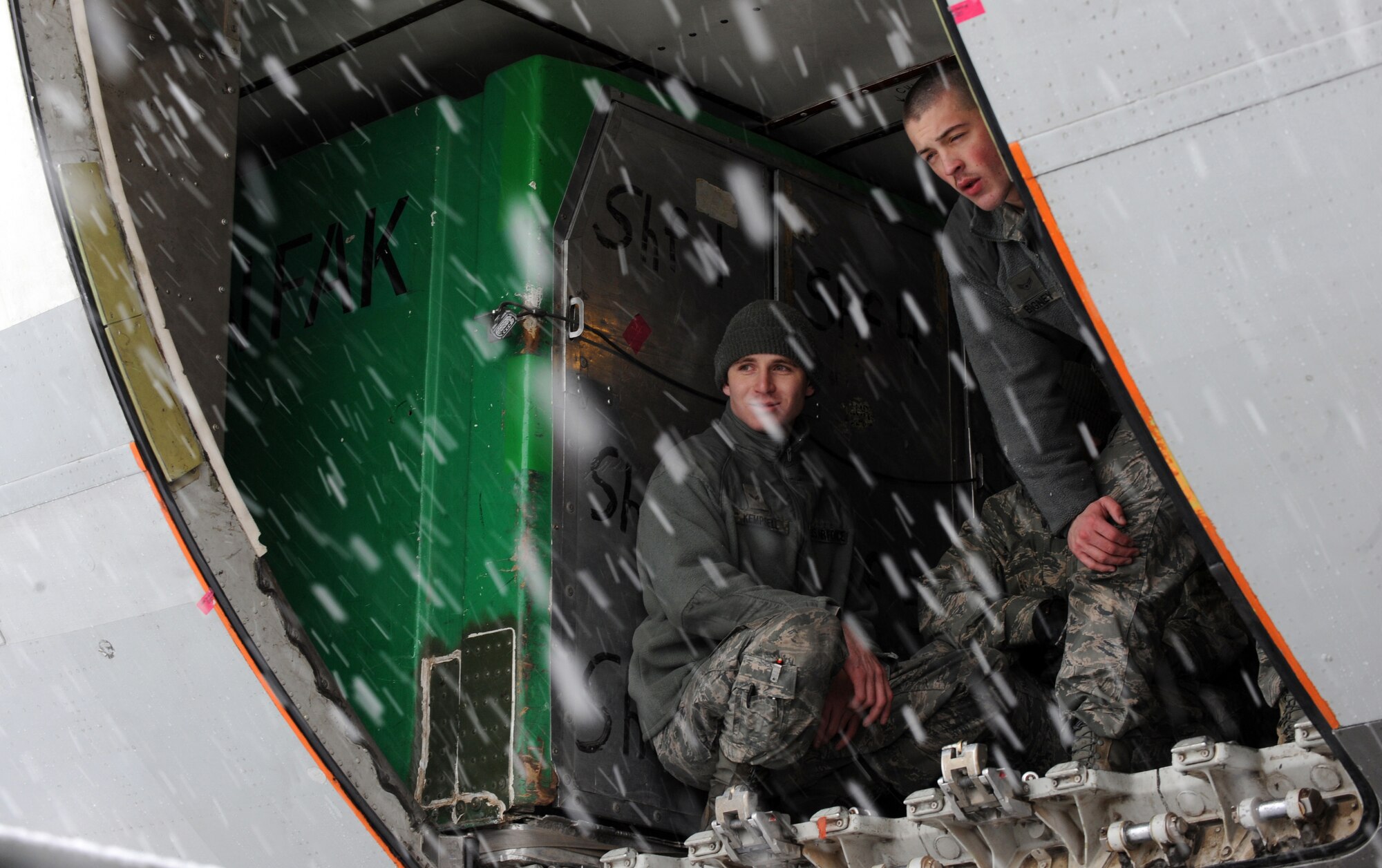 MOUNTAIN HOME AIR FORCE BASE, Idaho - - Airmen from the 366th Fighter Wing take a break from loading baggage inside an aircraft, March 7. More than 400 Airmen from across the 366th Fighter Wing are deploying in support of Operation Enduring Freedom. Airmen in a variety of non-aviation roles are scheduled to conduct a wide range of tasks to ensure the success of providing critical combat power capabilities. (U.S. Air Force photo by Senior Airman Debbie Lockhart)